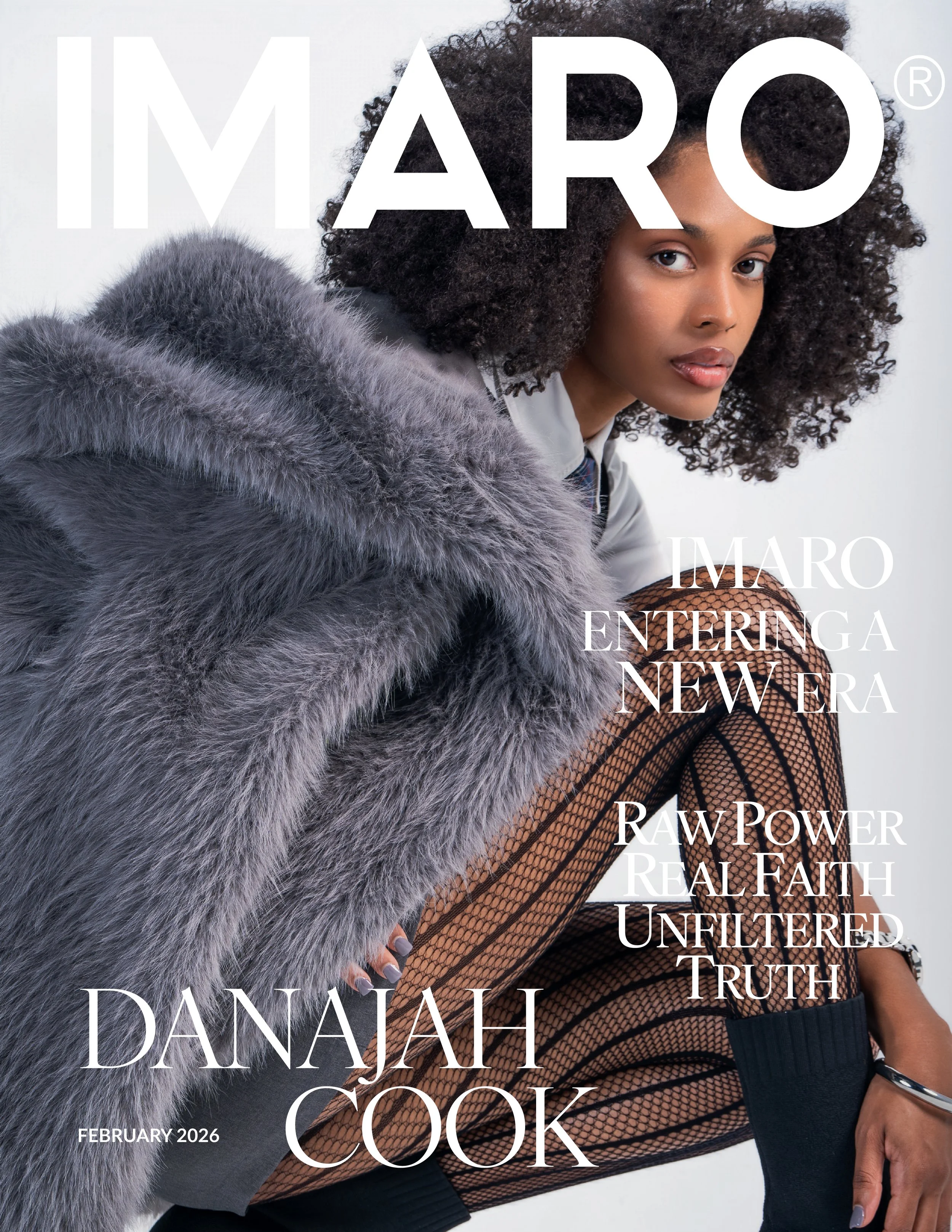 A woman with natural curly hair wearing a gray fur coat, sitting in front of a plain background. The cover has white text overlay with headlines about cultural and personal empowerment, featuring the name Danajah Cook and the date February 2026.