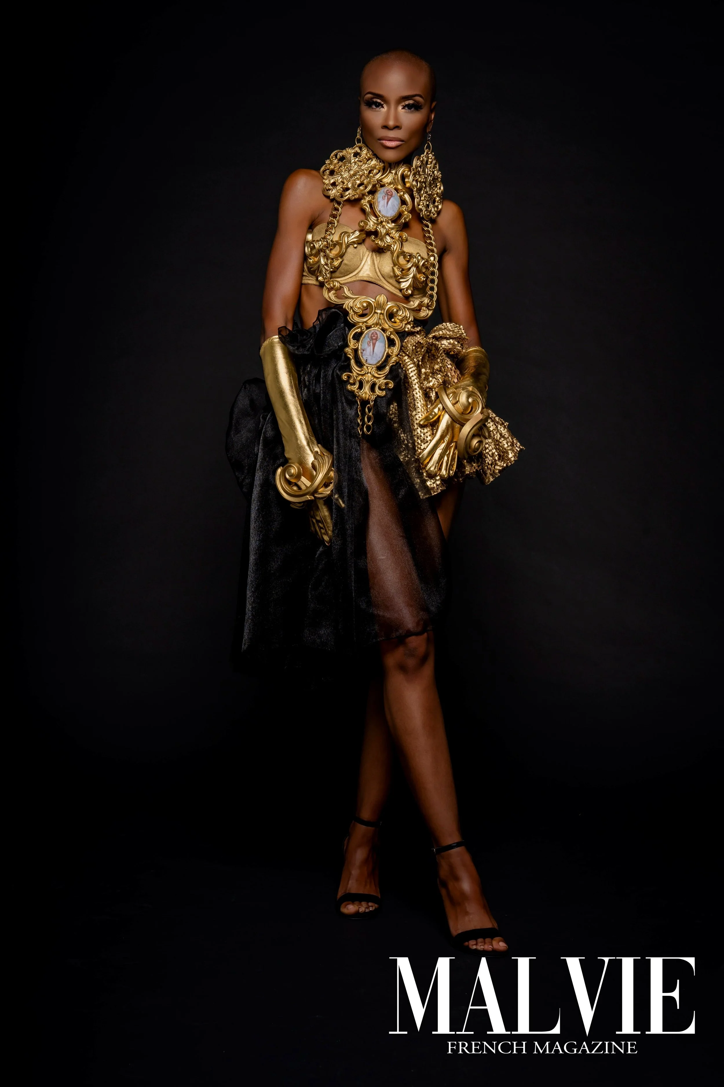 A woman wearing gold jewelry and black high heel shoes against a black background, with the text 'MALVIE FRENCH MAGAZINE' at the bottom.
