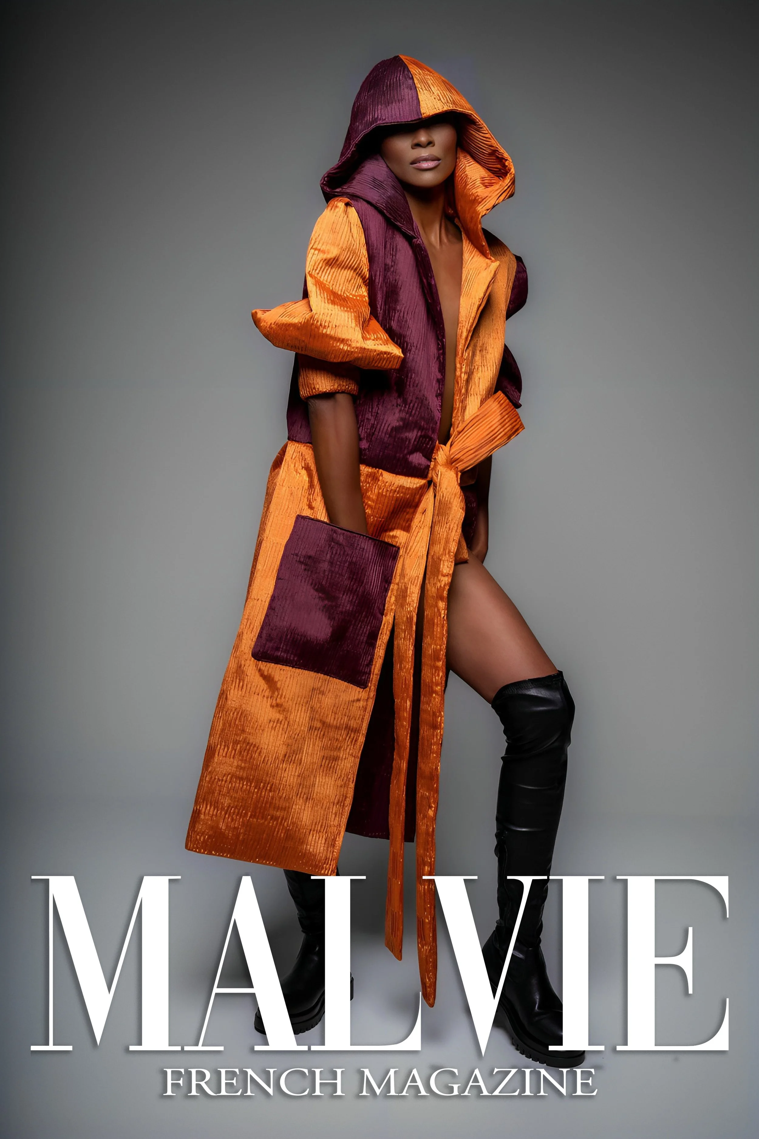 A woman in a long orange and purple hooded coat with thigh-high black boots poses against a gray background, with the text 'MALEVE' and 'FRENCH MAGAZINE' overlaid at the bottom.