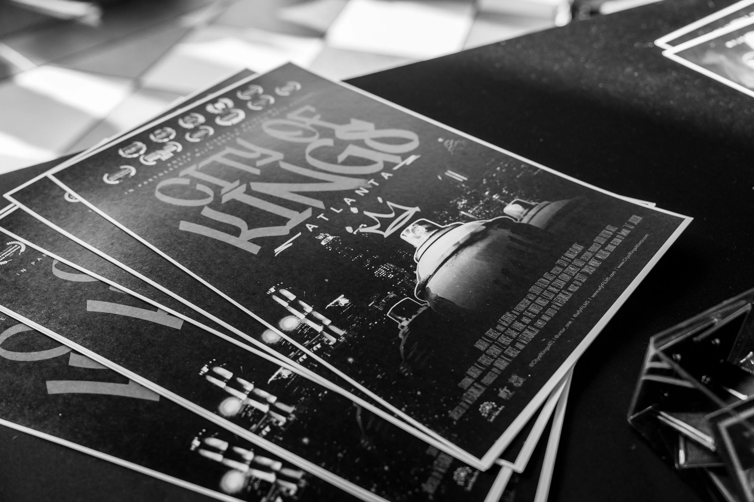 Black and white flyer for a ticketed event titled 'Guns & Roses' at a venue called 'The National.' The flyer features a cityscape skyline and an image of a spray paint can.