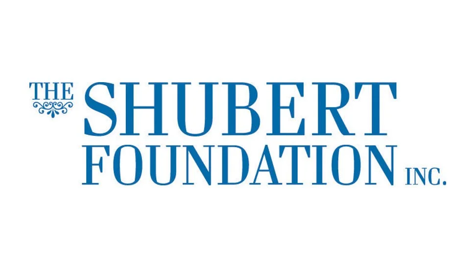 Logo of The Shubert Foundation Inc. in blue text with decorative flourish above 'Shubert'