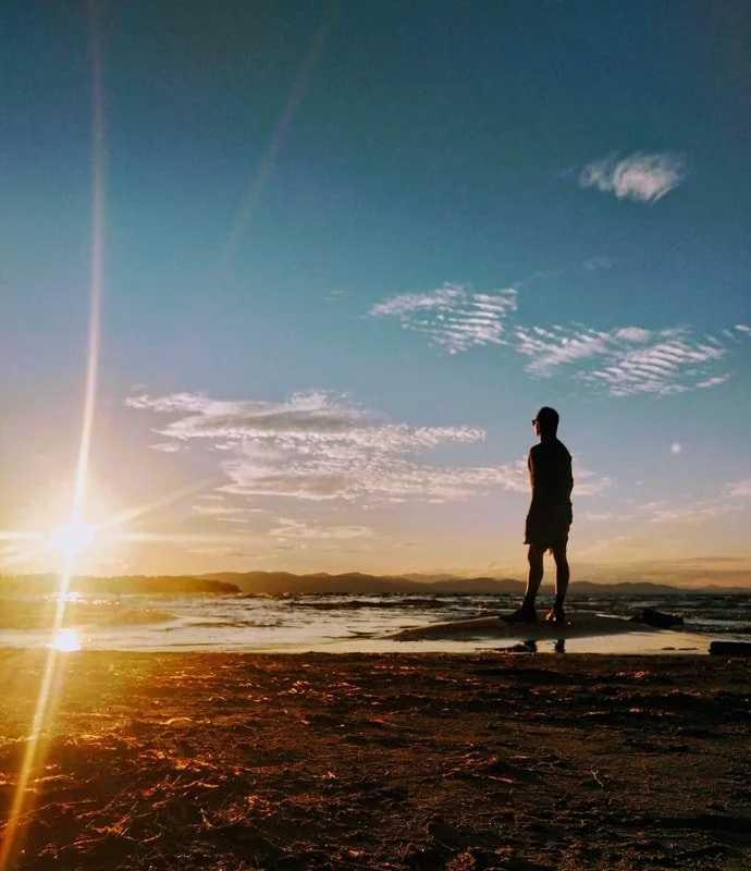 Dayton Shafer standing on a mountain with the sun setting