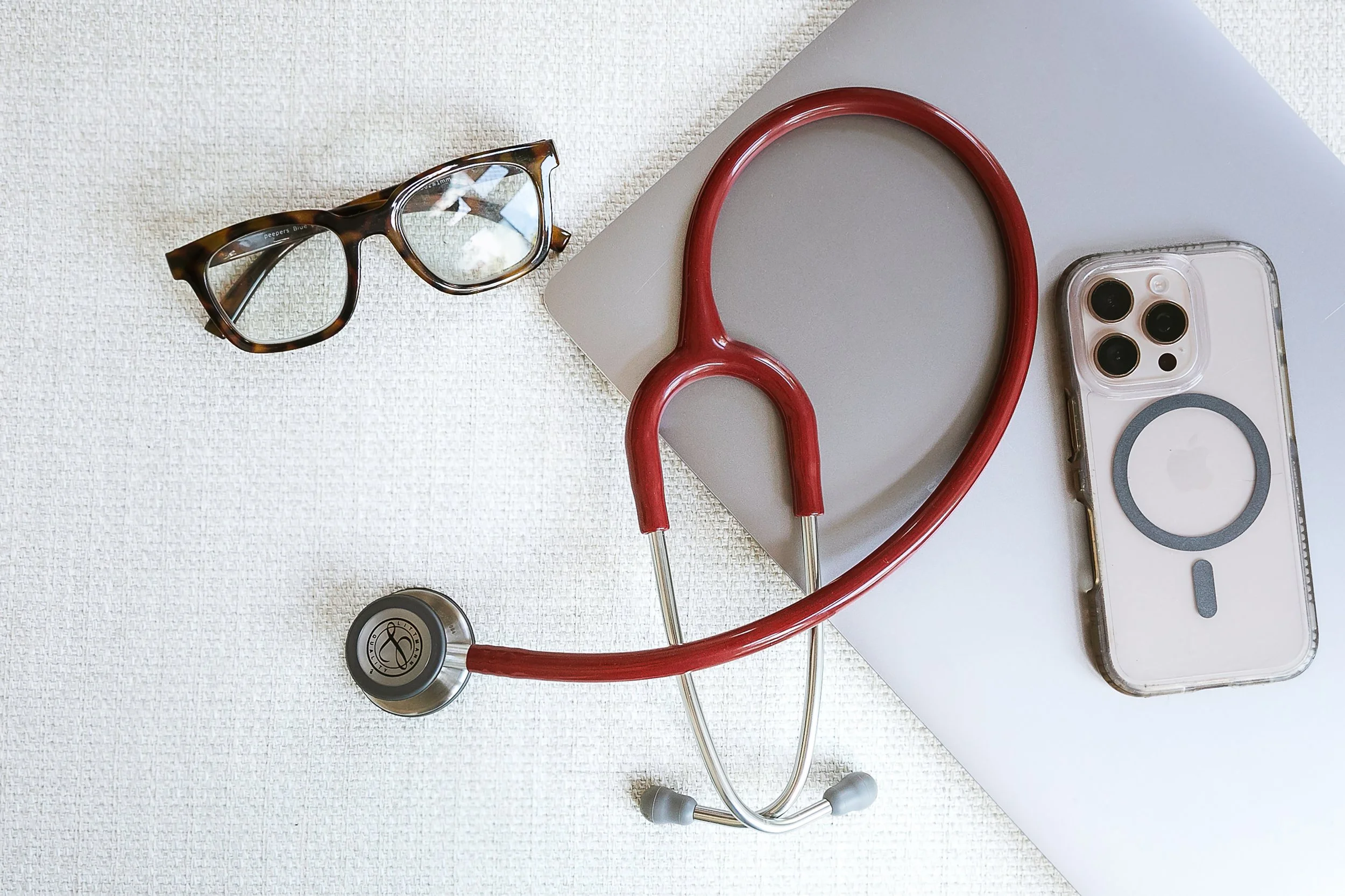 glasses, laptop, stethoscope, phone and laptop
