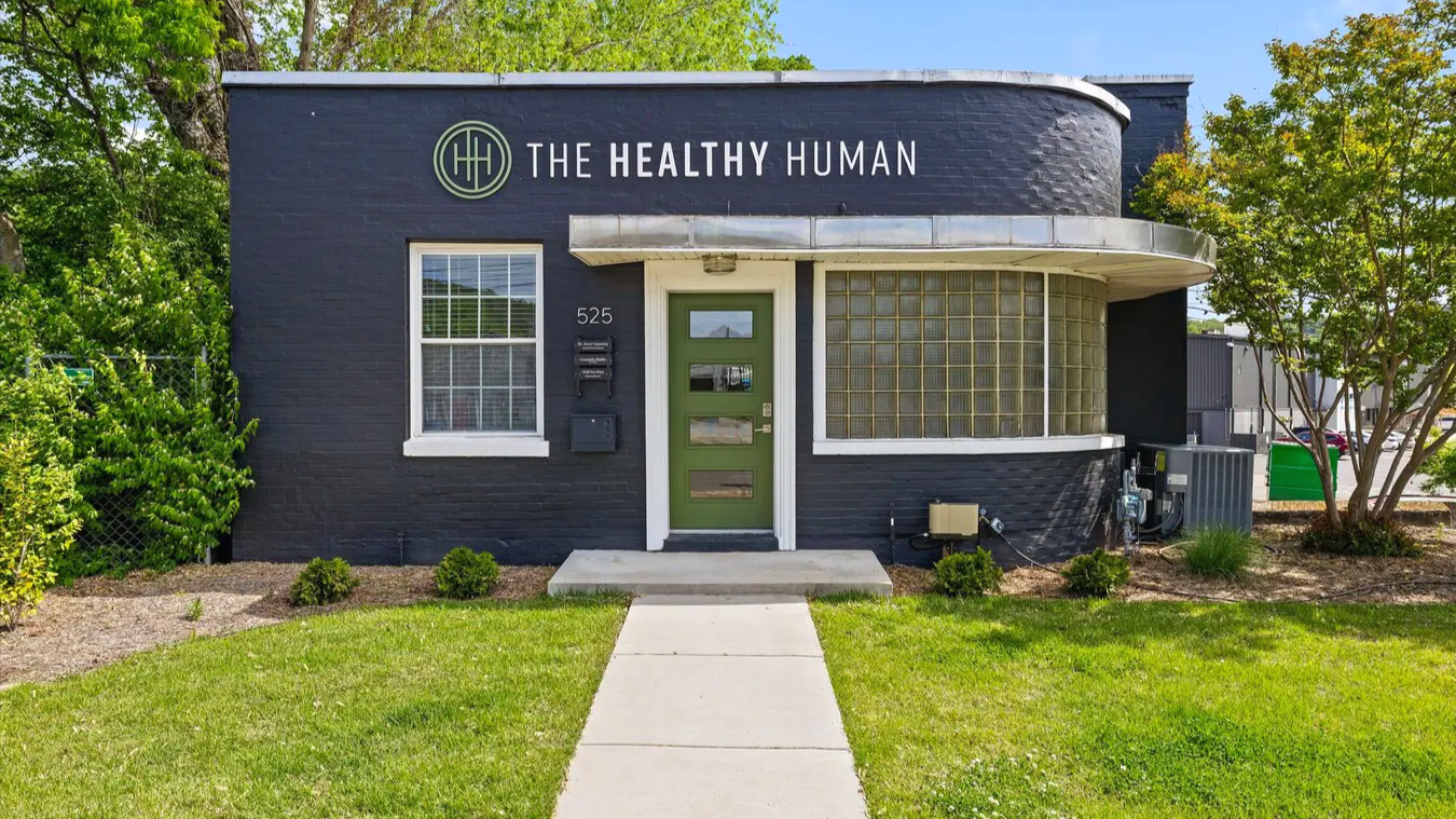 Cute dark blue building that says "The Healthy Human" on the front.