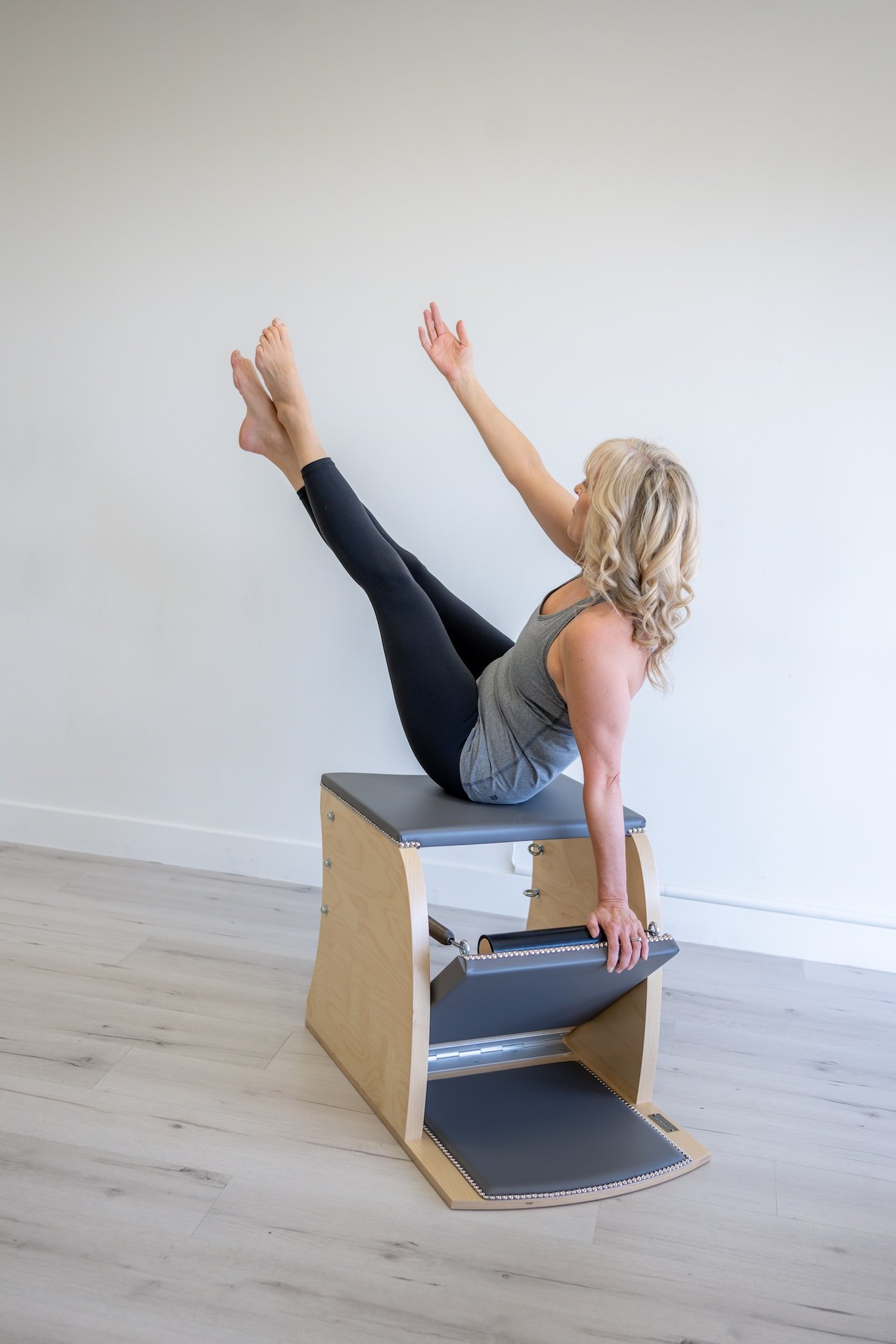 Wunda chair used in Classical Pilates workout for core strength and stability