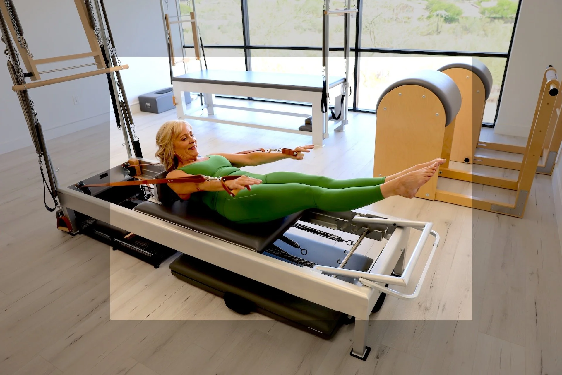 Client performing Classical Pilates reformer exercise under instructor guidance