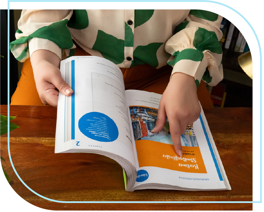 Shila pointing to German book