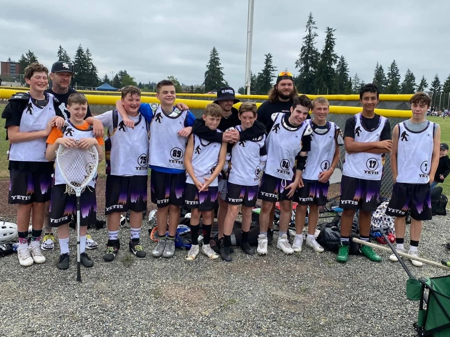 Yetis youth lacrosse team and coaches posing together after a game.