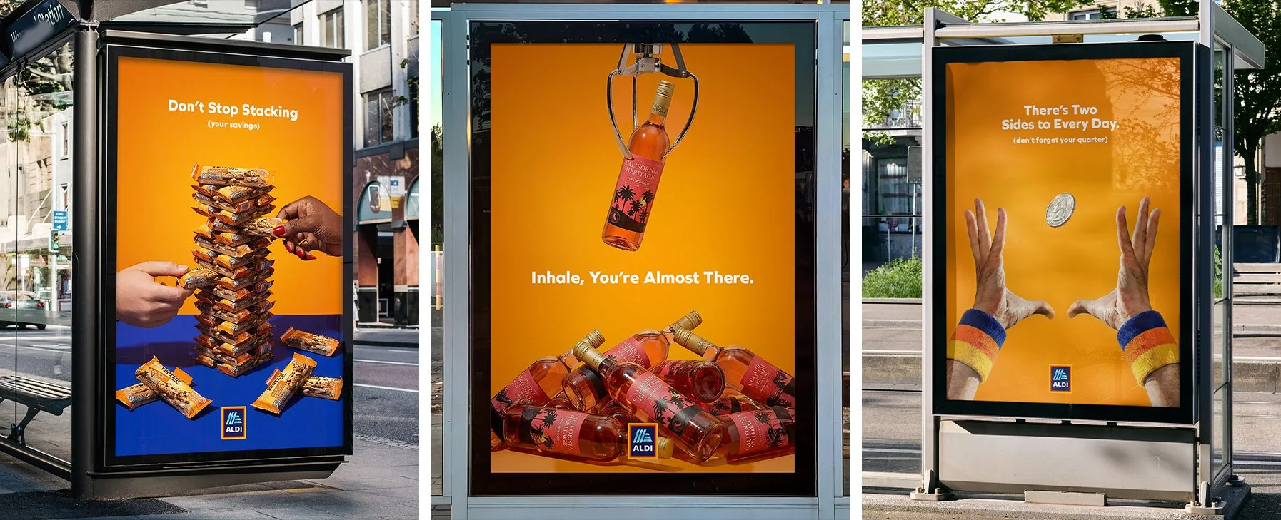 Three Aldi advertisement posters. The first shows a stack of snack bars with hands stacking them, with the text 'Don't Stop Stacking (your savings)'. The second features a bottle of rosé wine hanging from a bottle opener, with the text 'Inhale, You're Almost There' and a pile of rosé bottles. The third depicts two hands with chipped painted nails catching a coin falling into the air, with the text 'There's Two Sides to Every Day (don't forget your quarter)' and an Aldi logo.