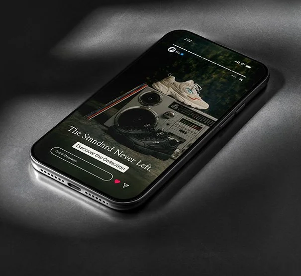 An iPhone displaying a website with images of sneakers and vintage audio equipment on a dark surface.
