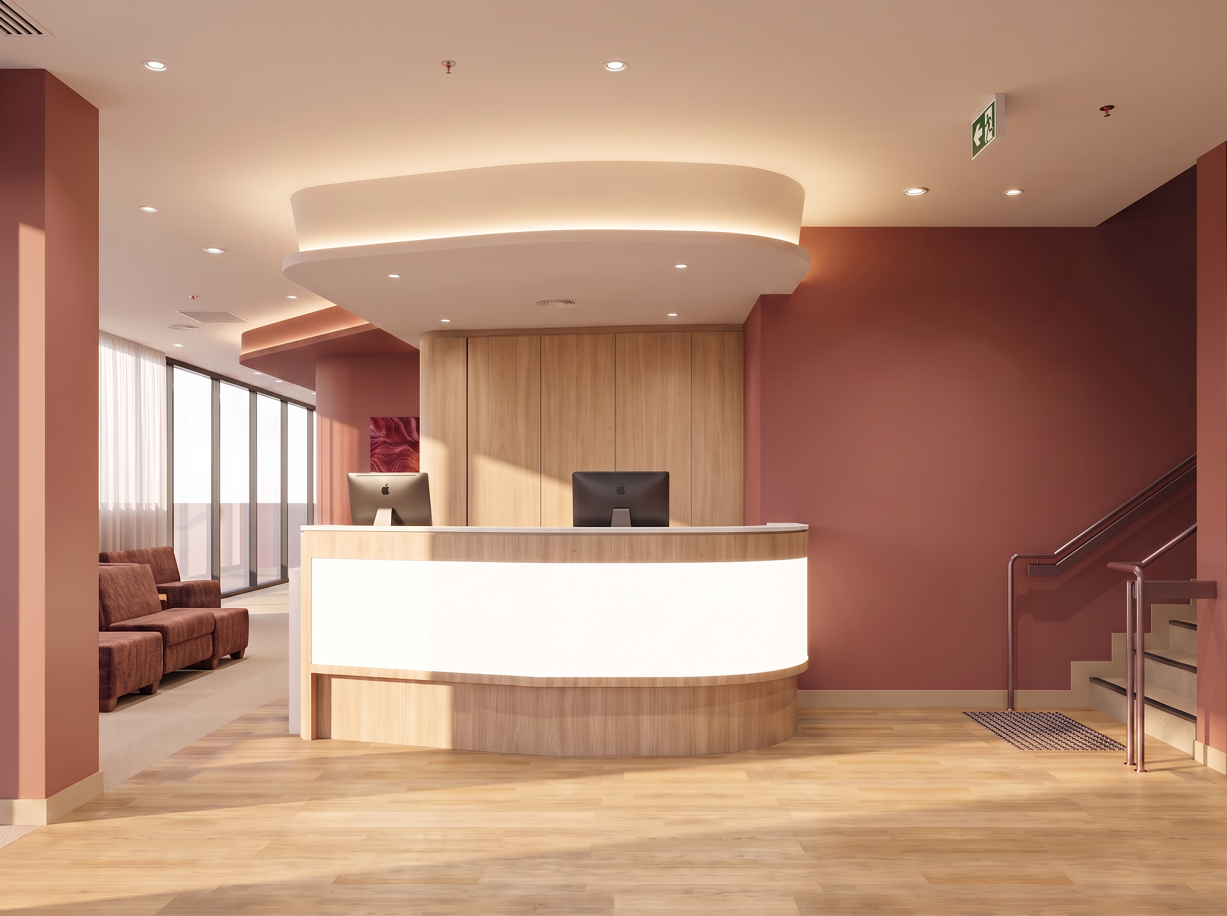 A modern reception area with a curved wooden front desk, two black iMac computers, a seating area with brown chairs, a stairway to the right, large windows with vertical blinds, warm lighting, and a maroon accent wall.