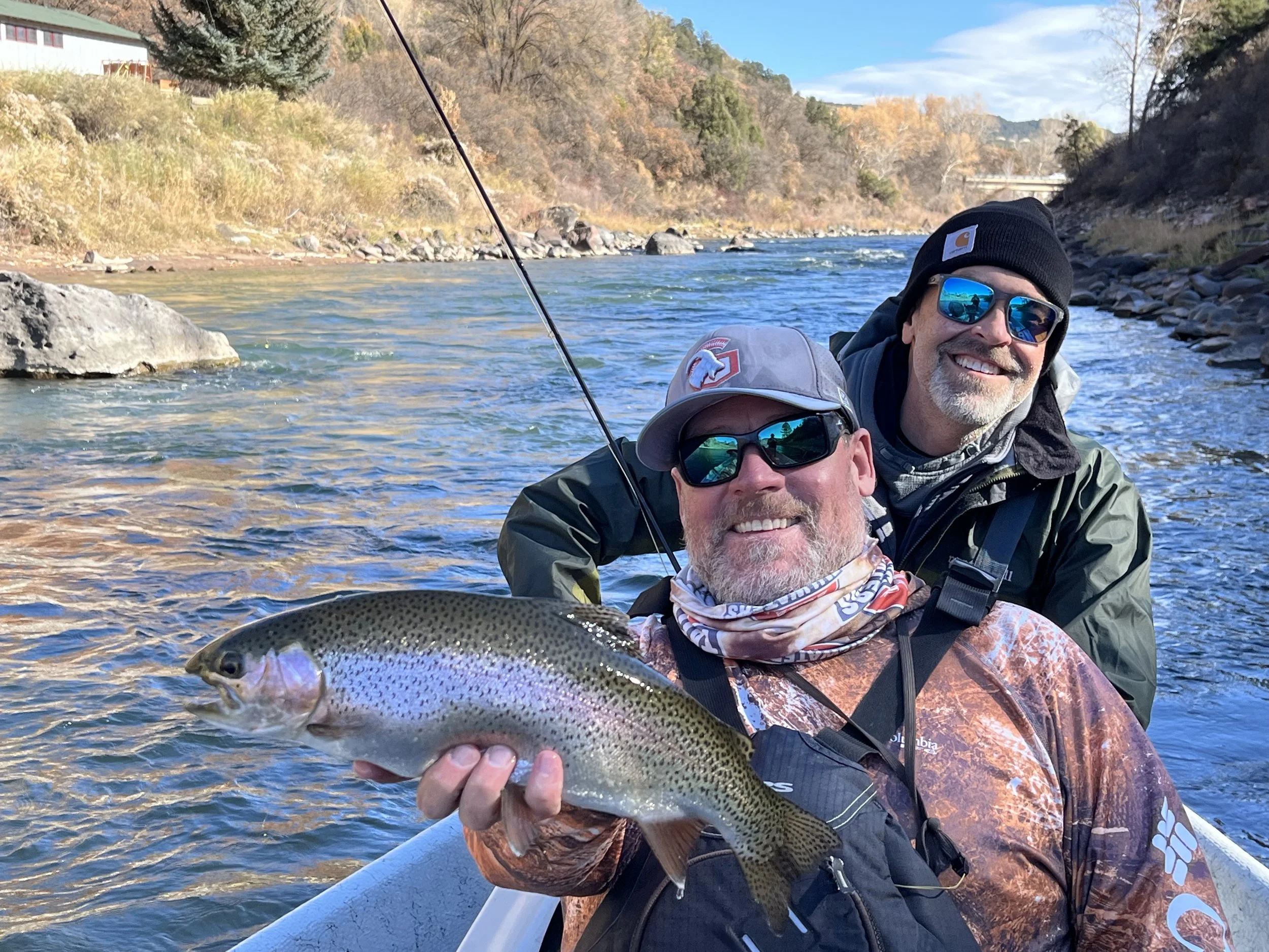 Jeremy Stott guiding clients on the Roaring Fork River near Glenwood Springs, Colorado — holding a rainbow trout