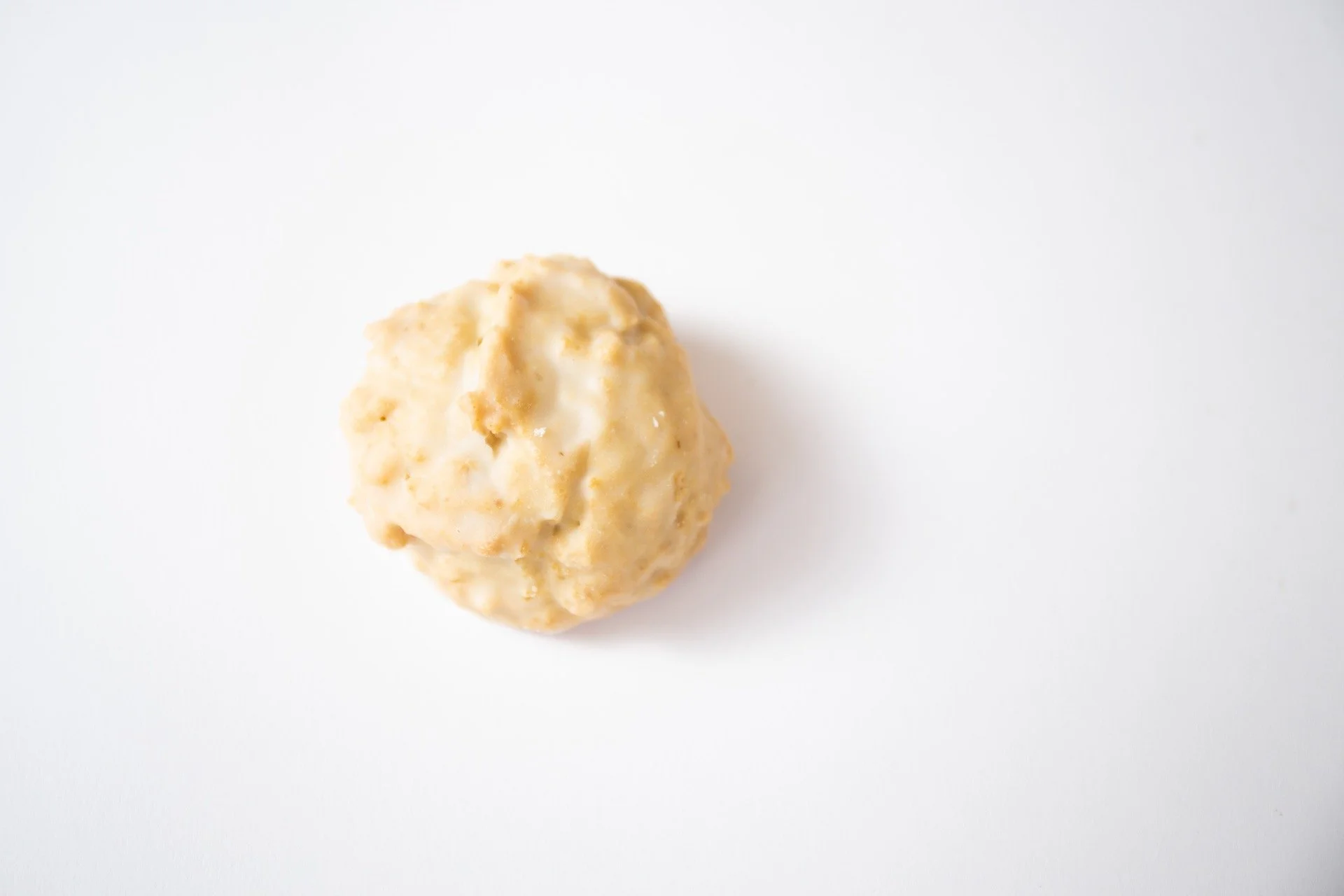 A fluffy maple scone on a white background