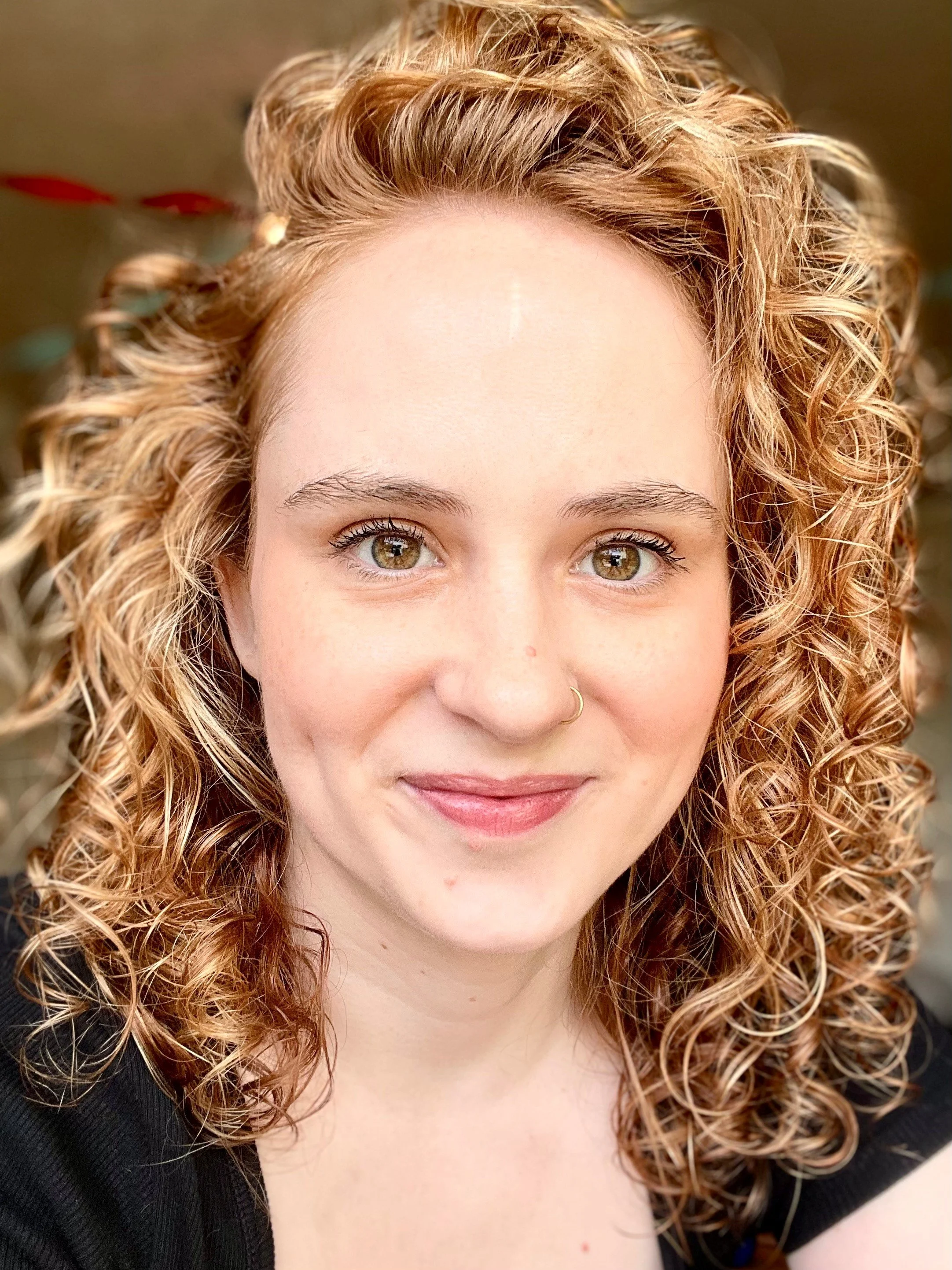 close-up of woman with shoulder-length curly red hair
