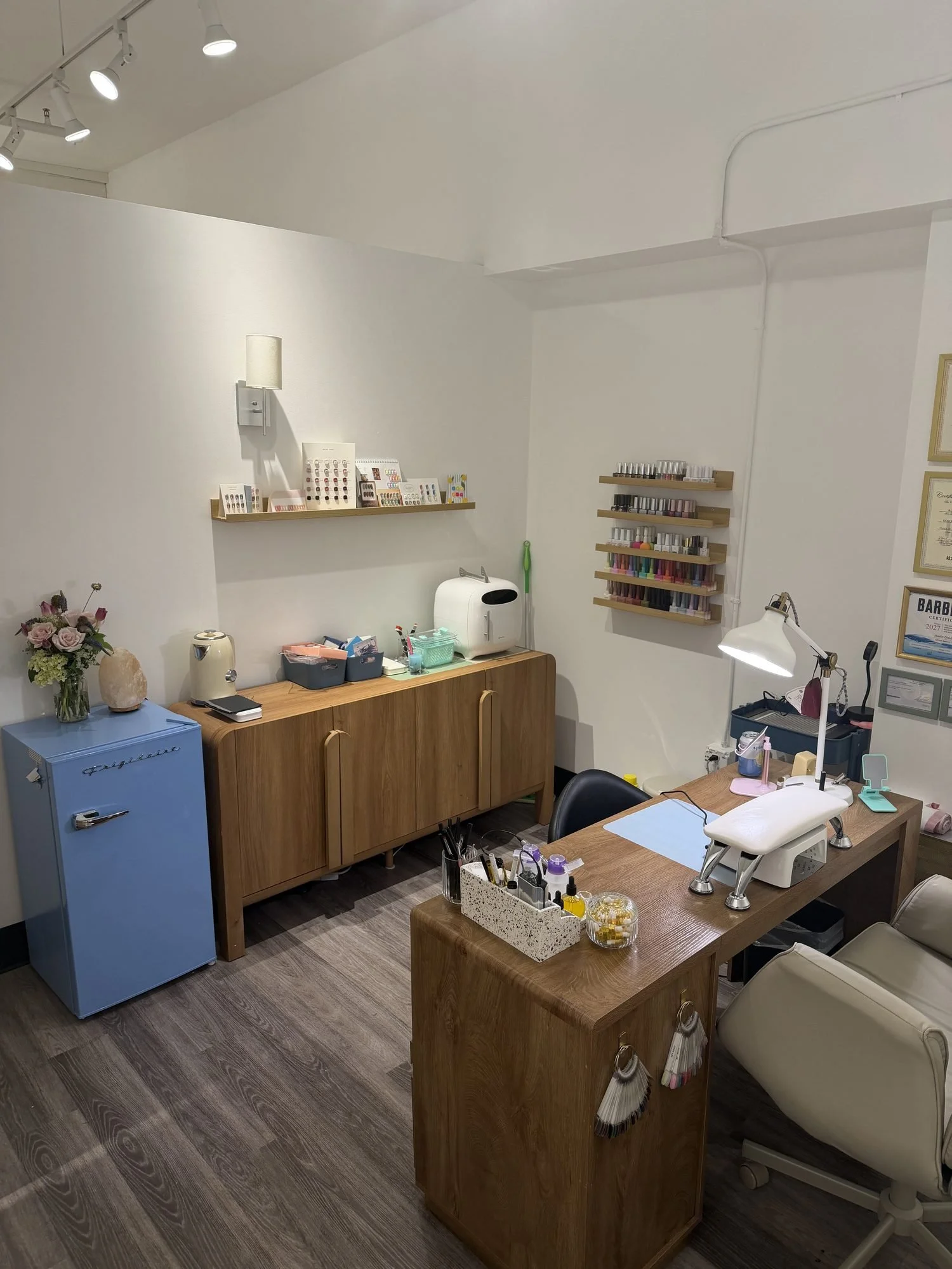 Cozy and inviting single-station nail salon interior with matching wood furnishings
