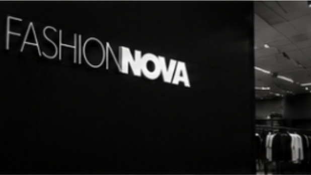 Black wall with the words 'FASHION NOVA' written on it.