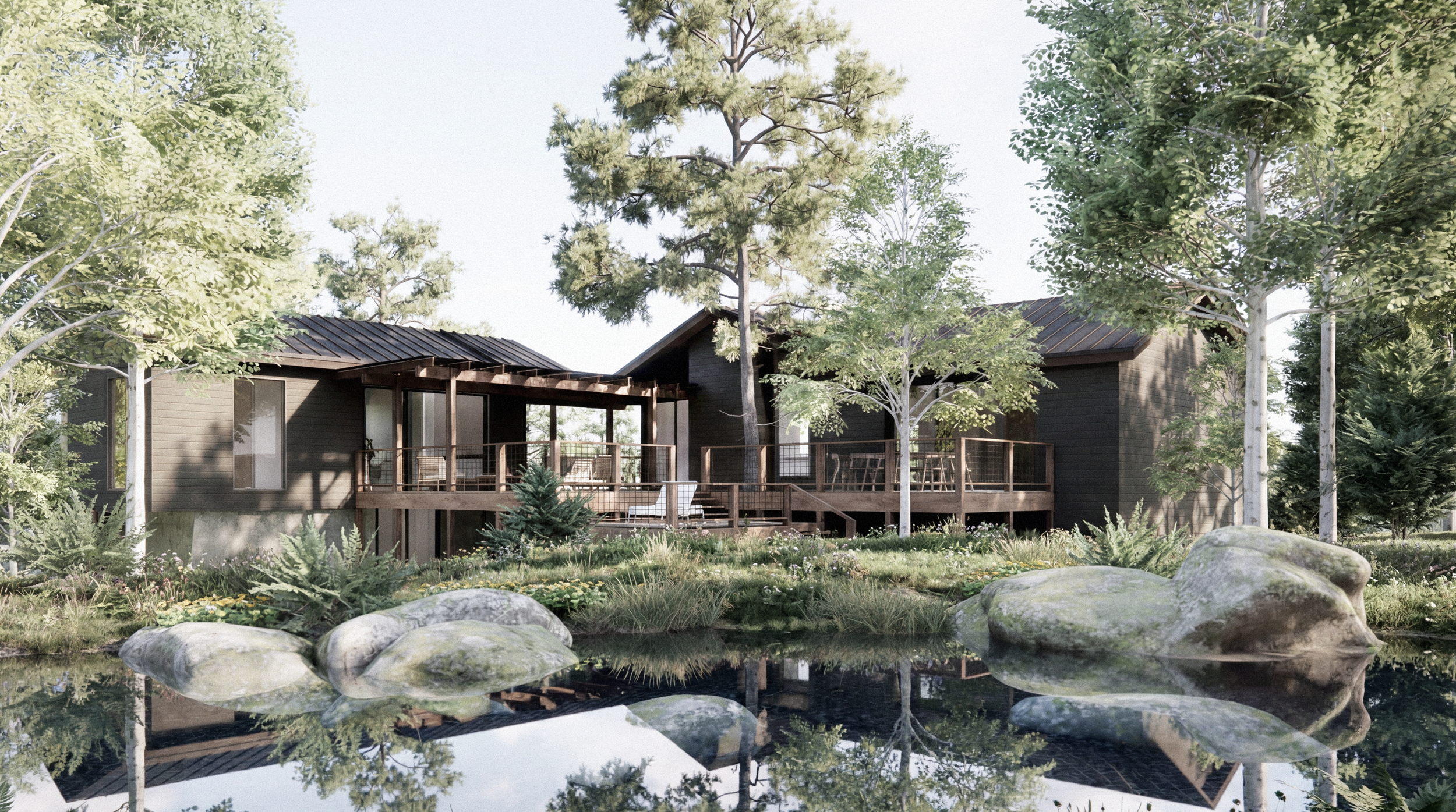 A modern house with dark exterior resembling wood, surrounded by trees and greenery, with a deck overlooking a pond with rocks and trees around.