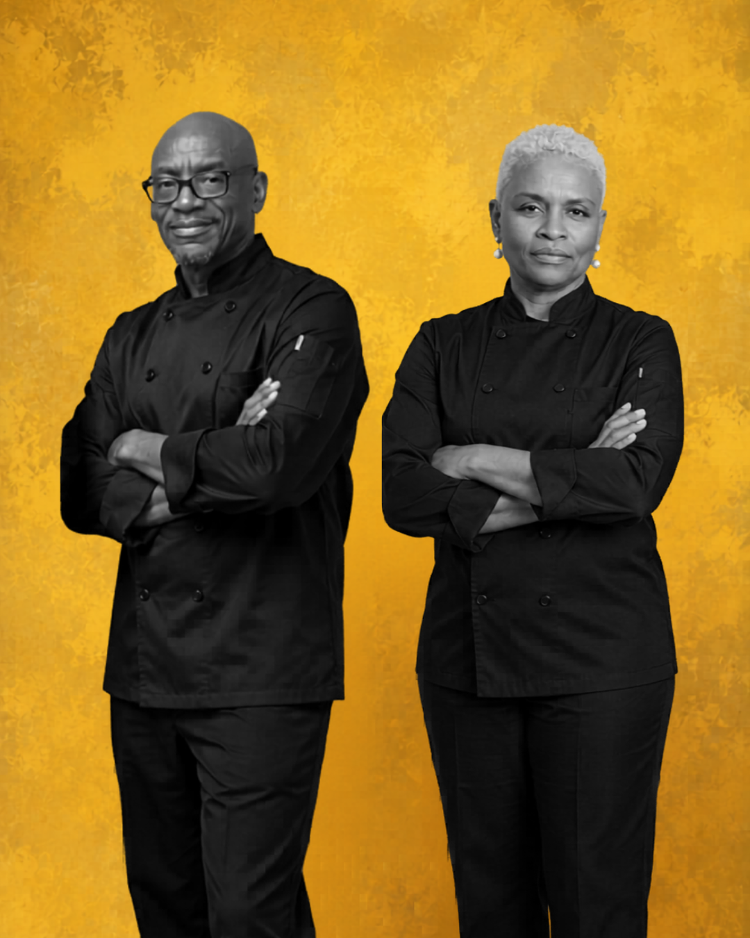 Two professional chefs, a man and a woman, standing with arms crossed against a yellow background. Both are dressed in black chef uniforms.