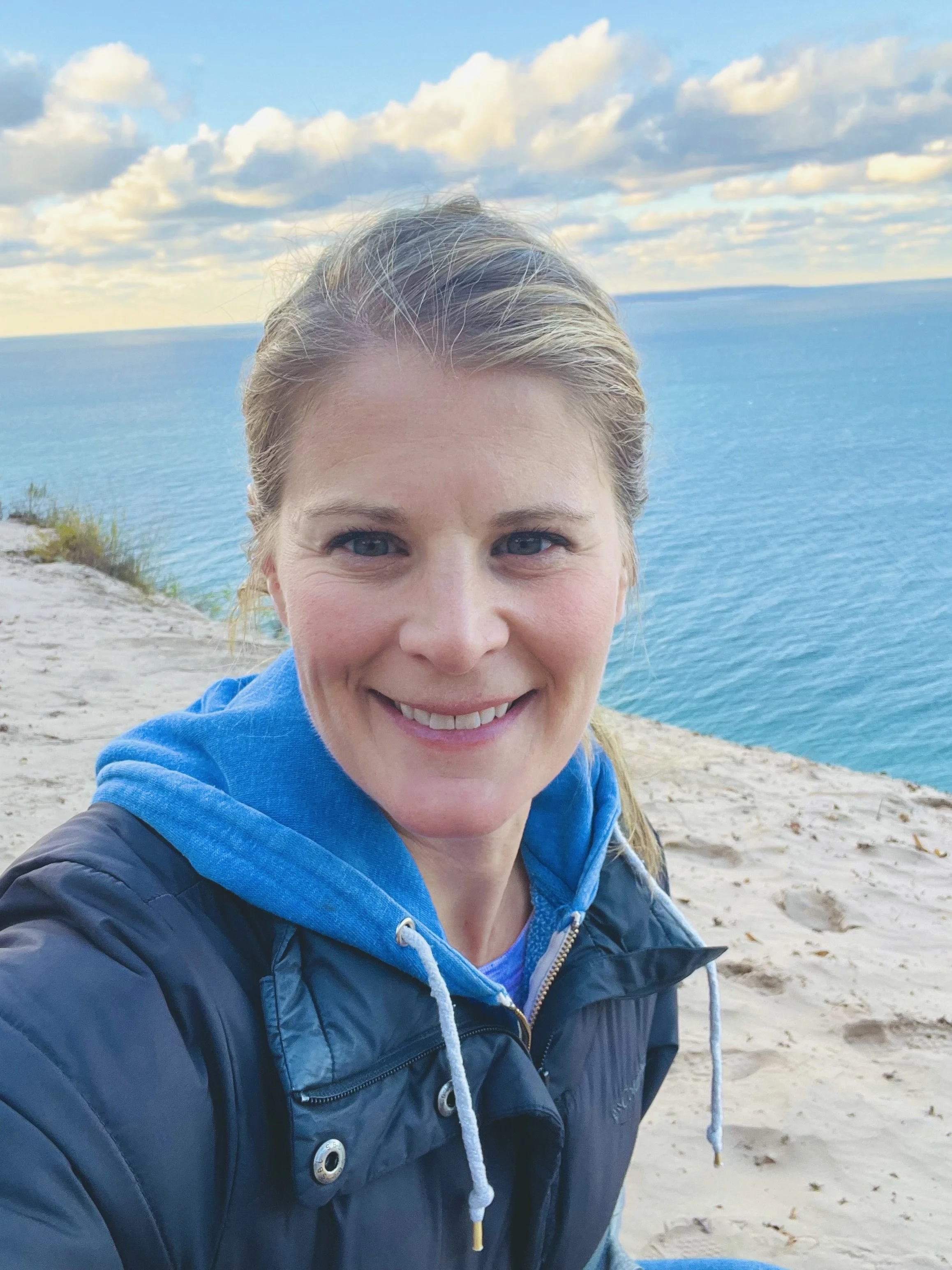 Rhonda Hoyer outdoors reflecting near the Great Lakes shoreline