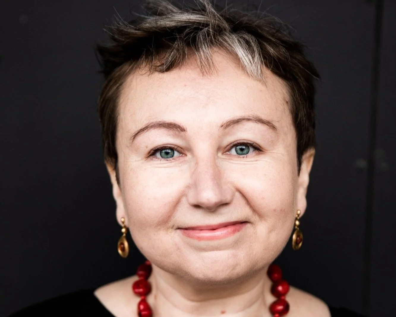 Headshot of female lawyer with short hair and earings.