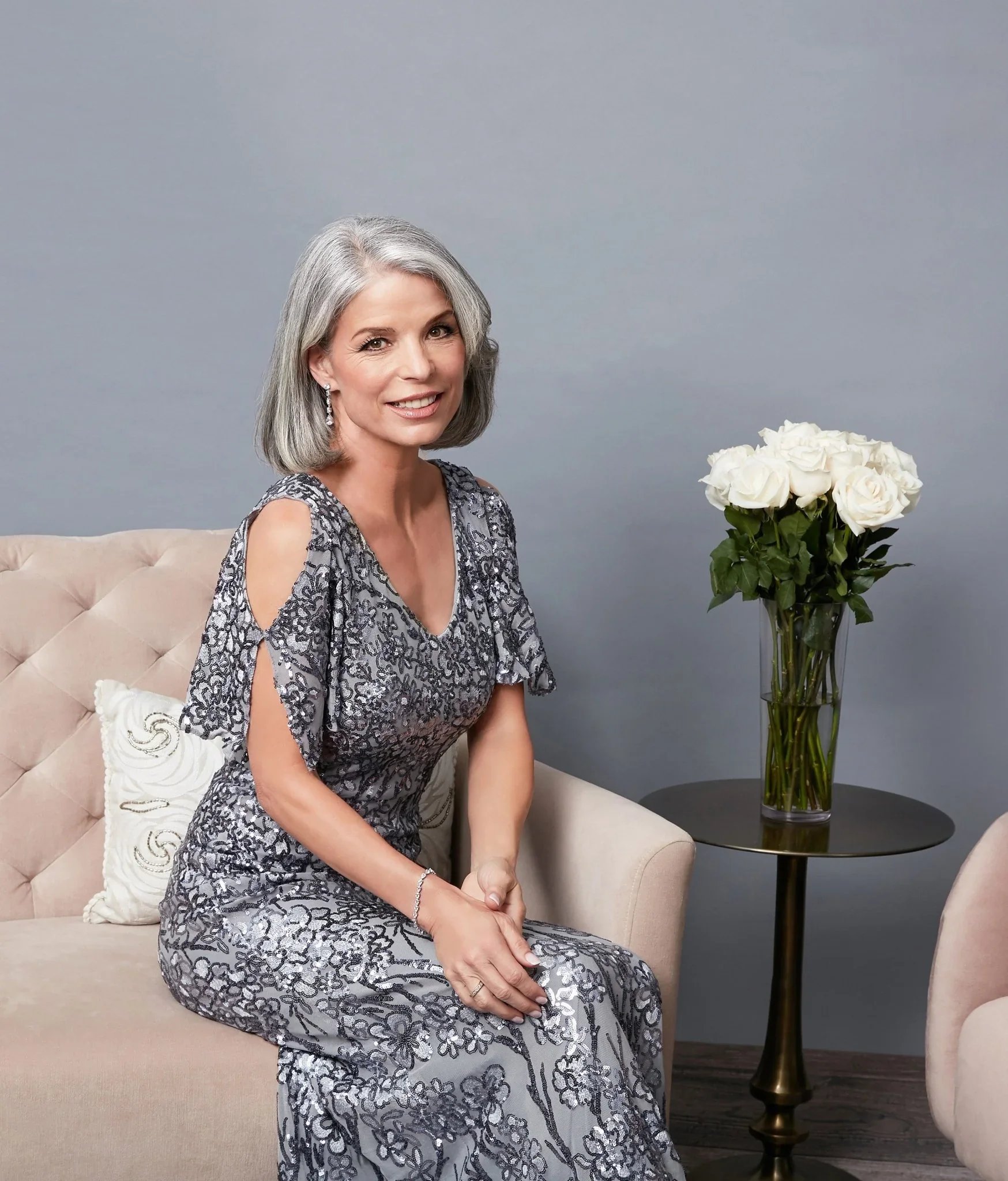 A woman wearing a silver sequin evening dress