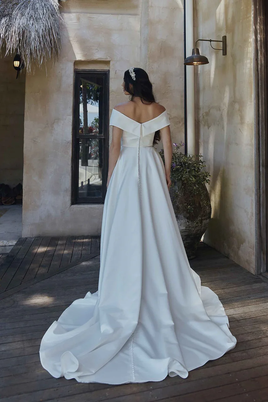 DIANA-TC2328-WEDDING-DRESS-VINTAGE-WHITE-SOFT-SATIN-OFF-SHOULDER-WRAP-BODICE-WITH-BUTTON-DETAILED-TRAIN-TANIA-OLSEN-BRIDAL.jpg.webp
