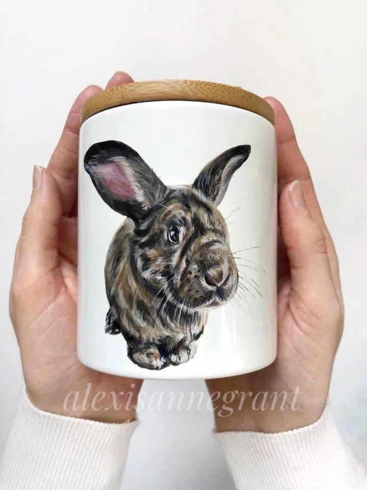 two hands holding a bunny portrait mug hand painted by alexis Anne grant
