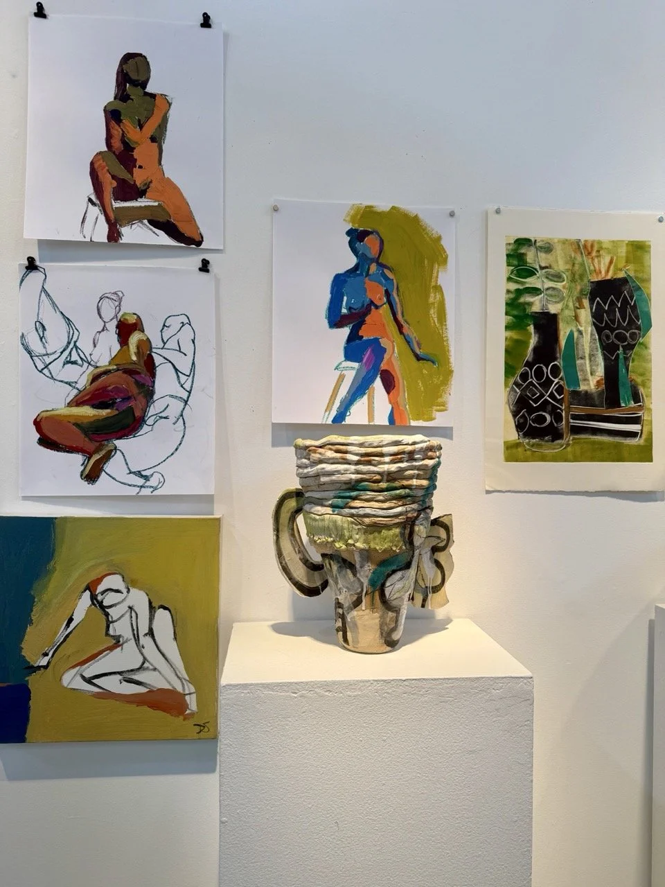 Display of six artworks featuring abstracted human figures and pottery in an art gallery setting.