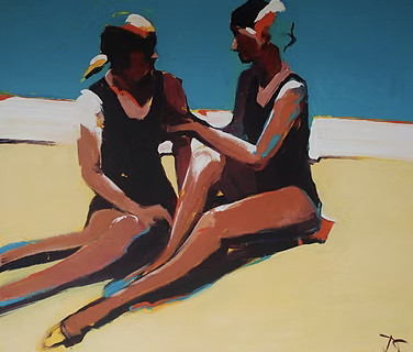Two women in swimsuits with towels on their heads sitting on a beach, engaging in conversation against a blue sky.