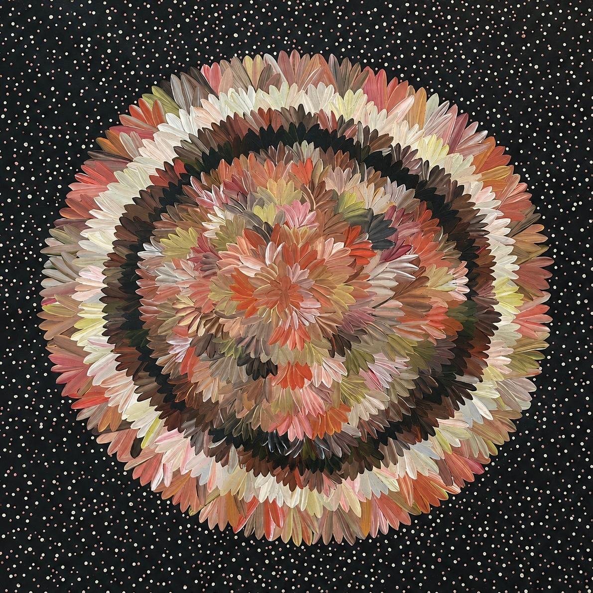 A large, circular, floral arrangement made of layers of multicolored feathers on a black background with white dots.