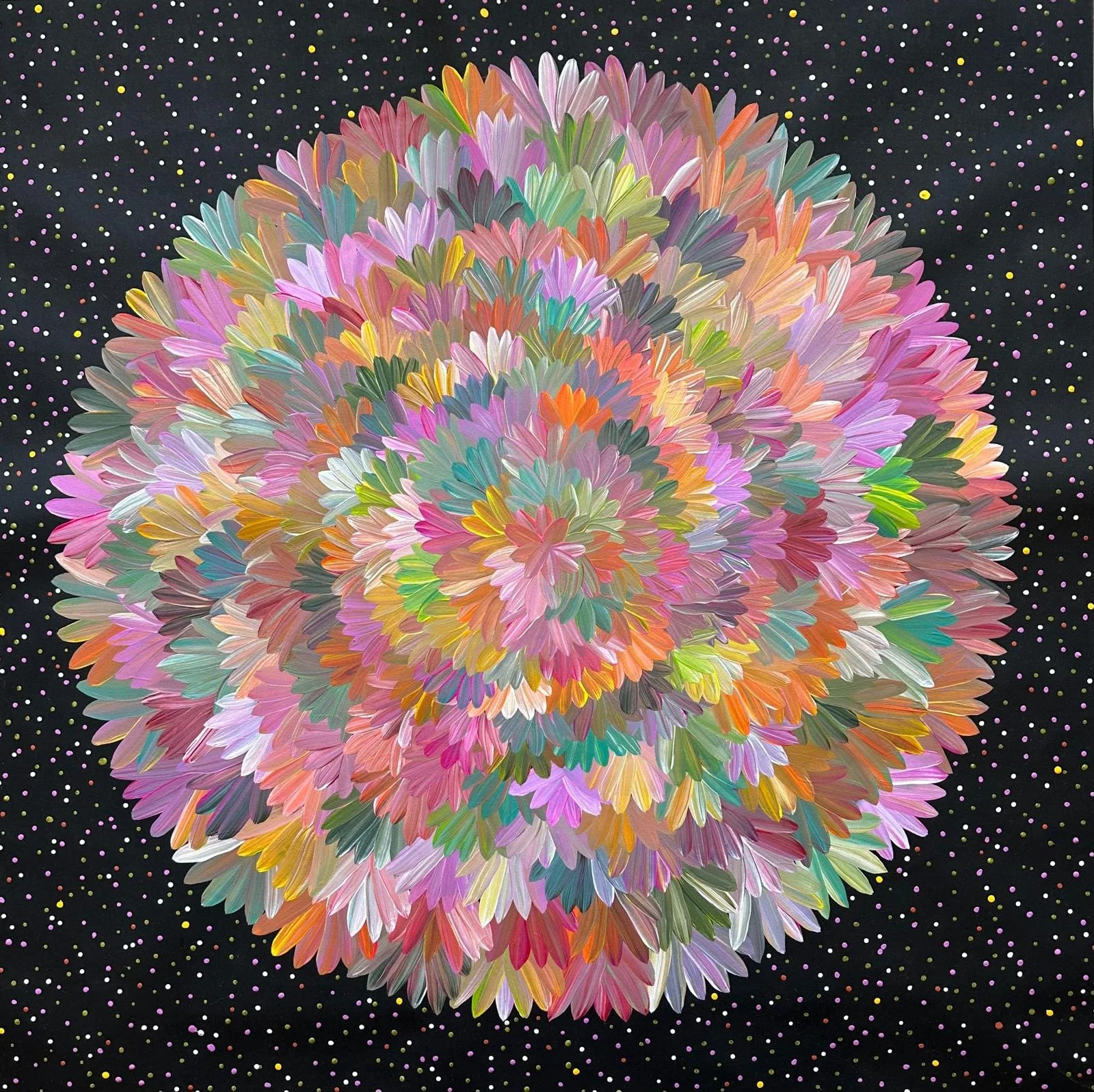 Colorful abstract flower-like sculpture composed of layered petal shapes with a multicolored fashion, set against a dark backdrop decorated with tiny multicolored dots.