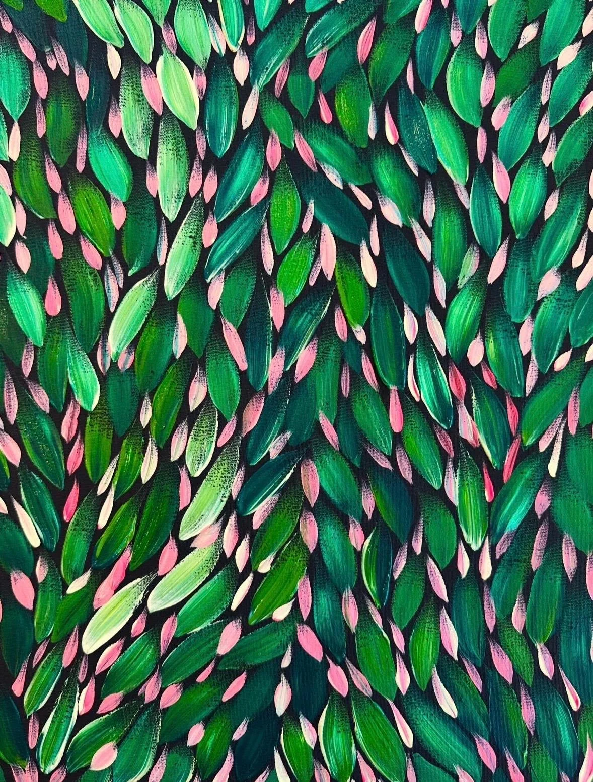 Close-up of a colorful abstract painting featuring green and pink leaves with black background.