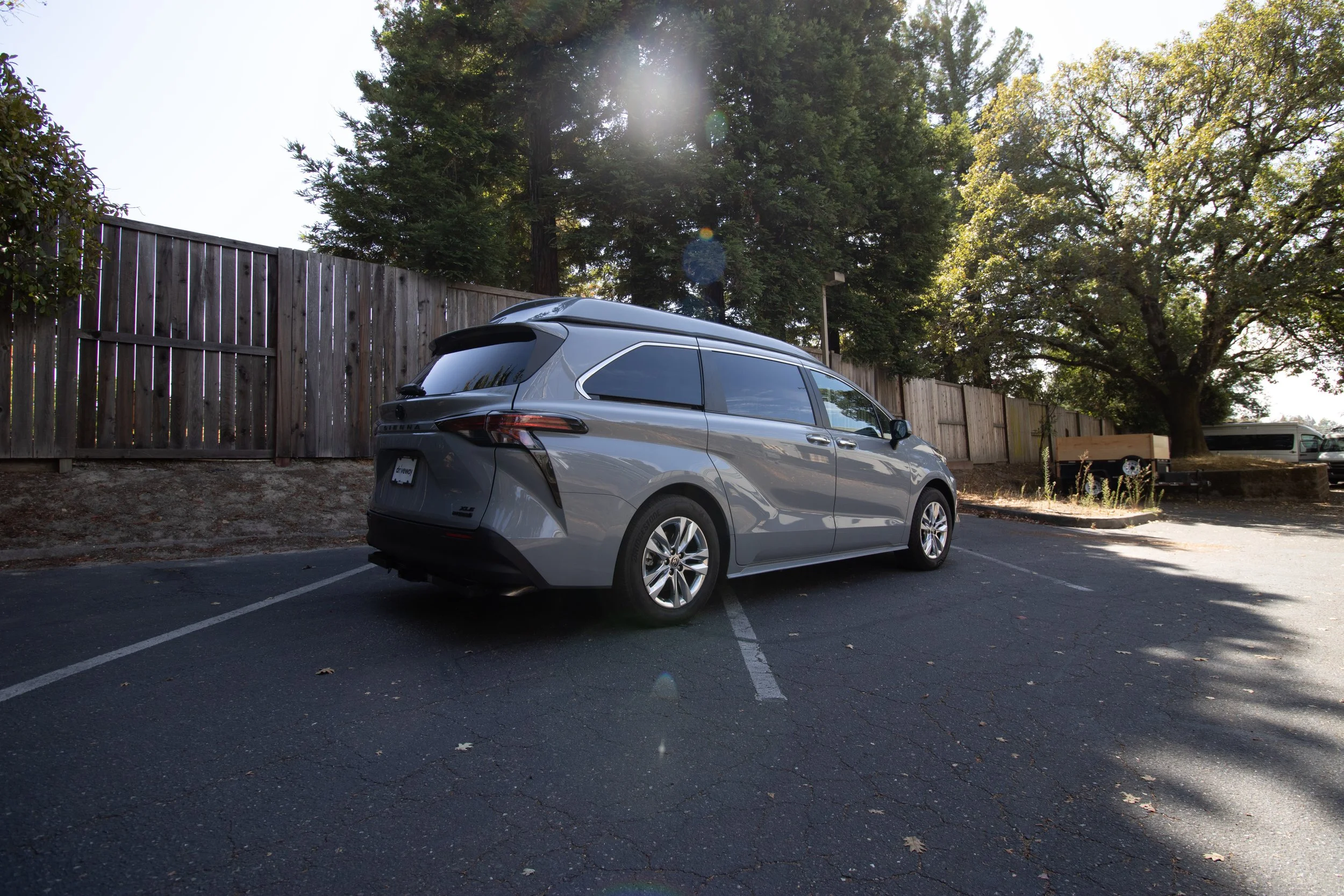 grey toyota sienna with a pop-top roof that is closed