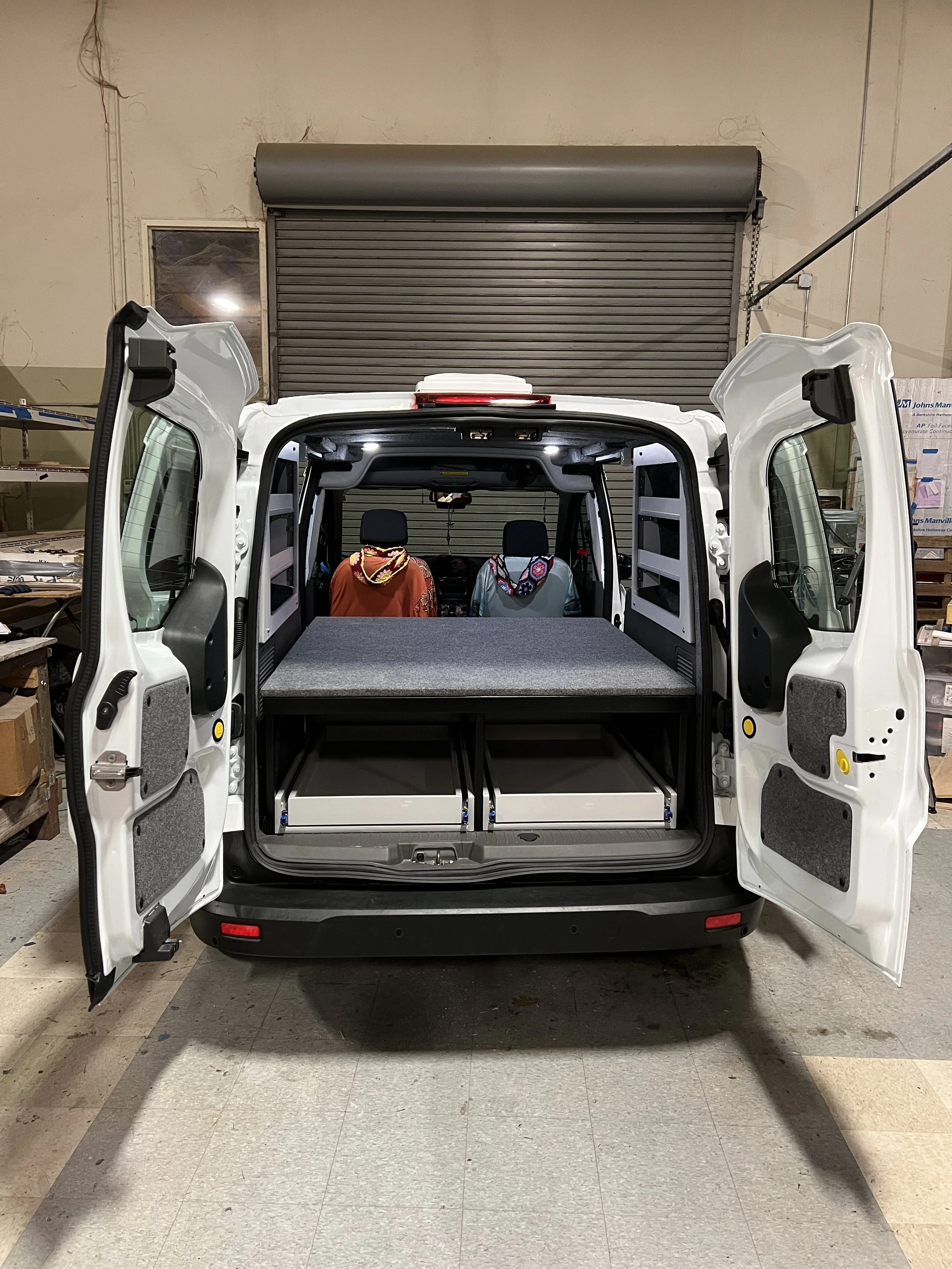 van in a shop with rear doors open
