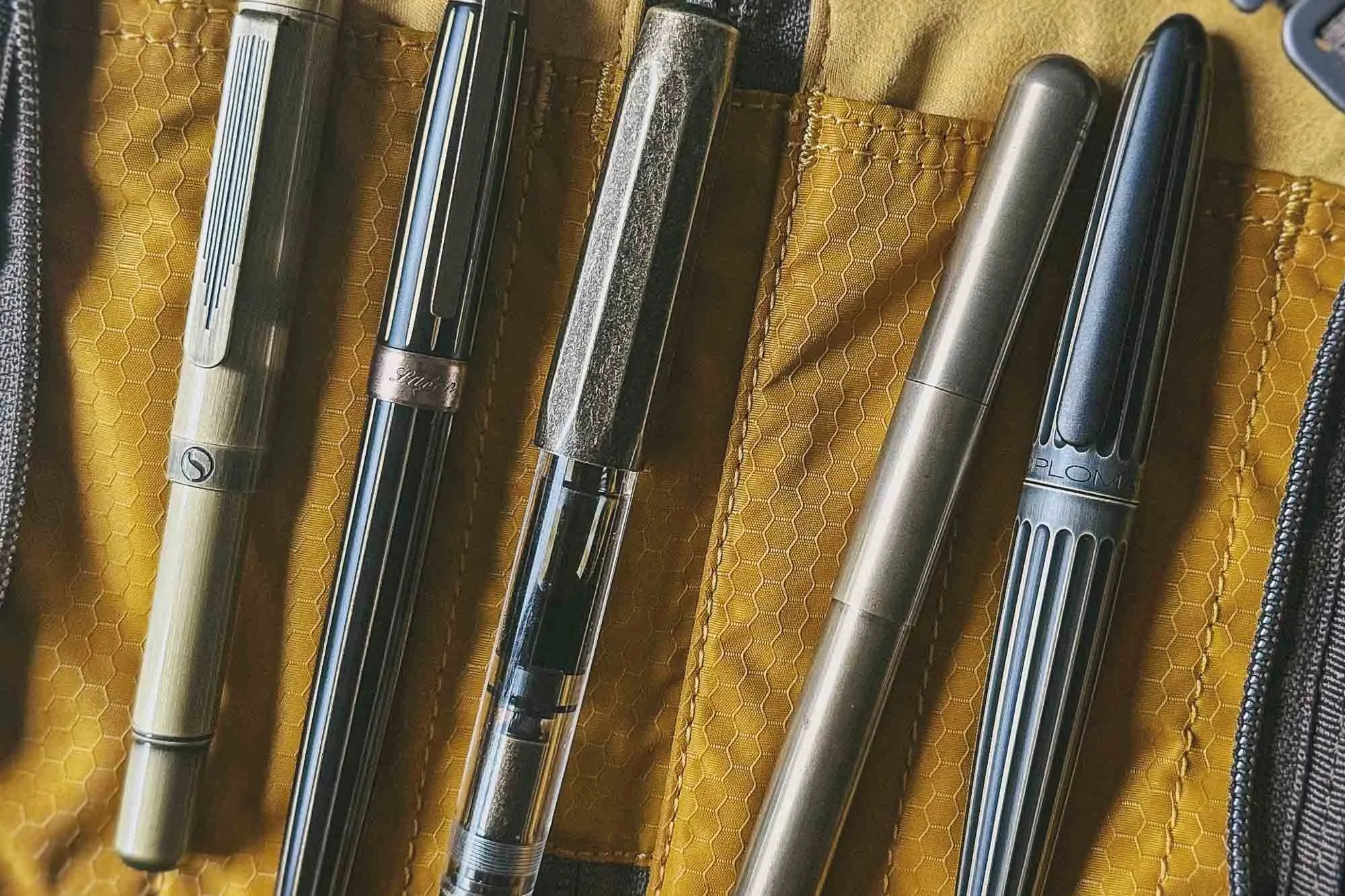 A desk setup with fountain pens and stationery, illustrating a Desktop Nerd Journal post about collecting pens and when too many options start getting in the way.