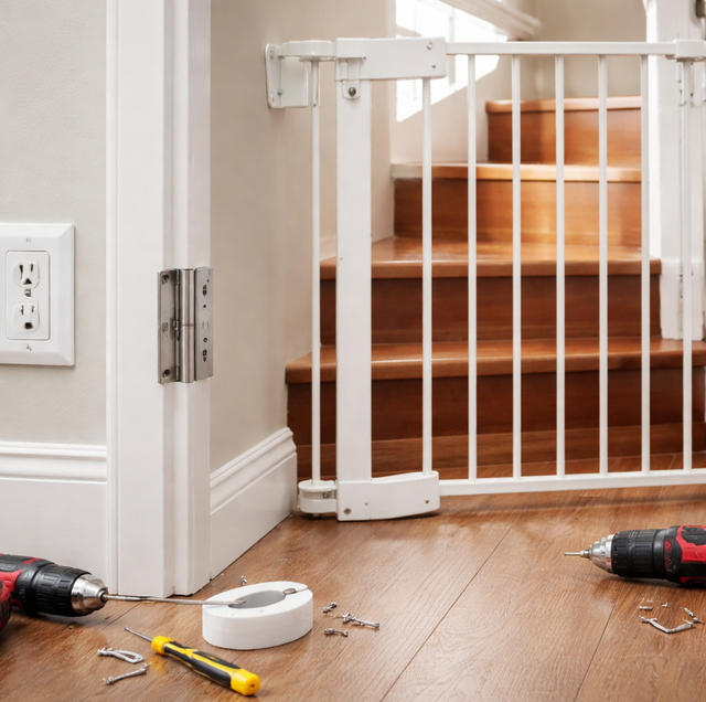 toddler reaching toward low wall outlet near open stair gate