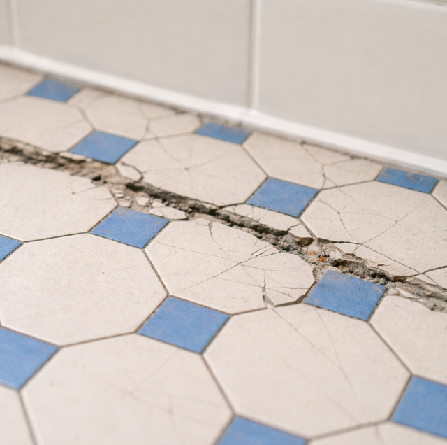 cracked grout lines on bathroom tile wall