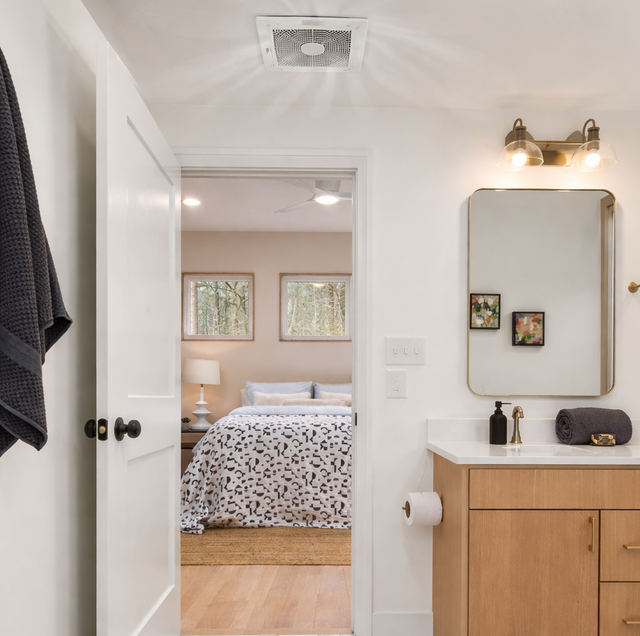 foggy bathroom mirror beside vent grille coated in dust