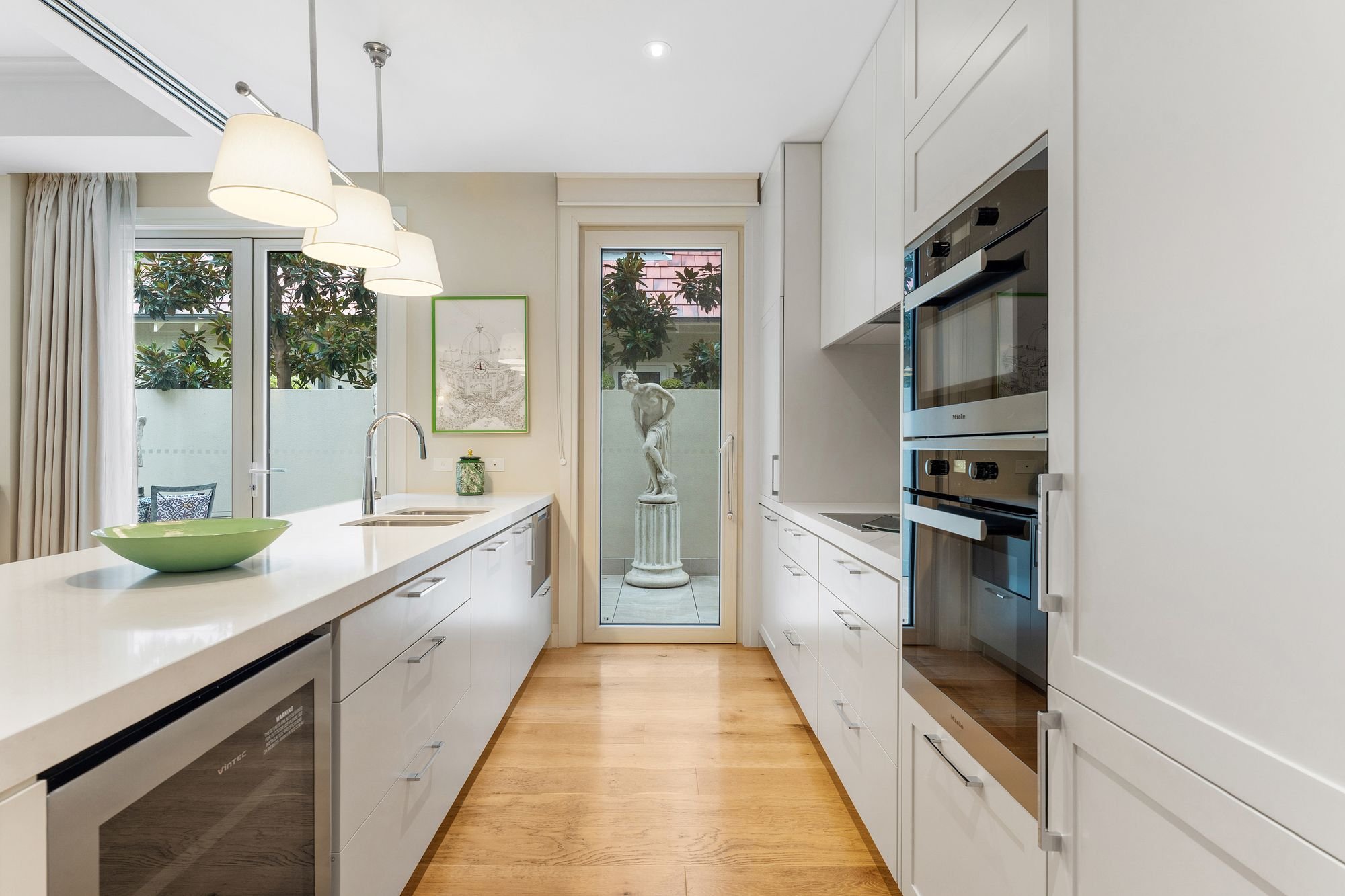 Well appointed kitchen with integrated oven, cooktop, dishwasher, stone benchtops and generous storage.