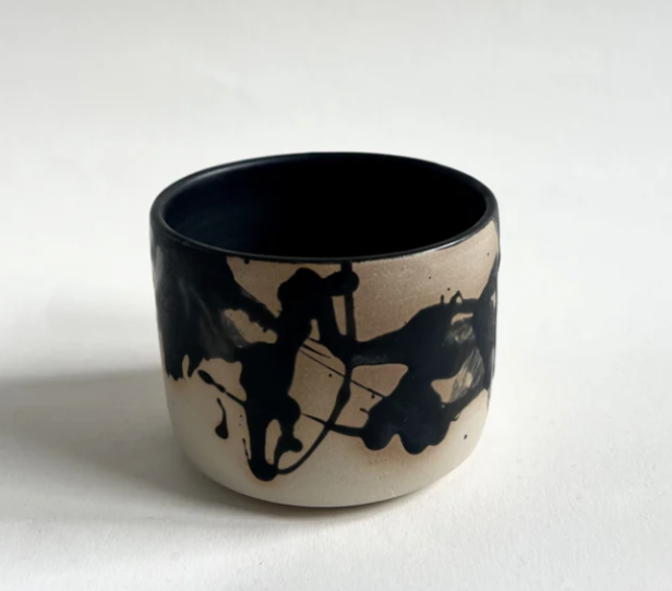 Schwarz-weiße Keramikschale mit abstraktem Design auf weißem Hintergrund.