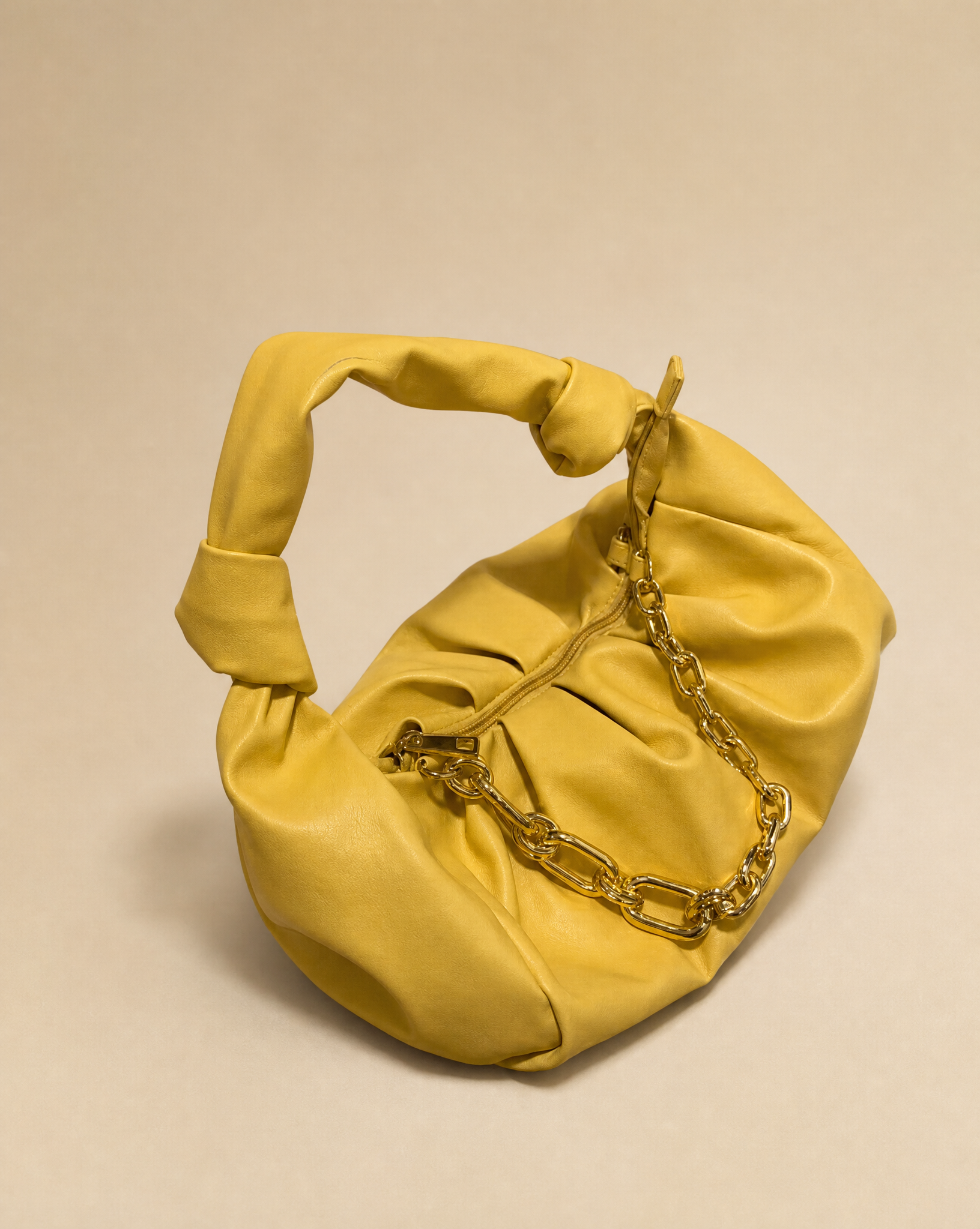 Generated with Kive.ai - Yellow ruched handbag Make a product shot only bag.png