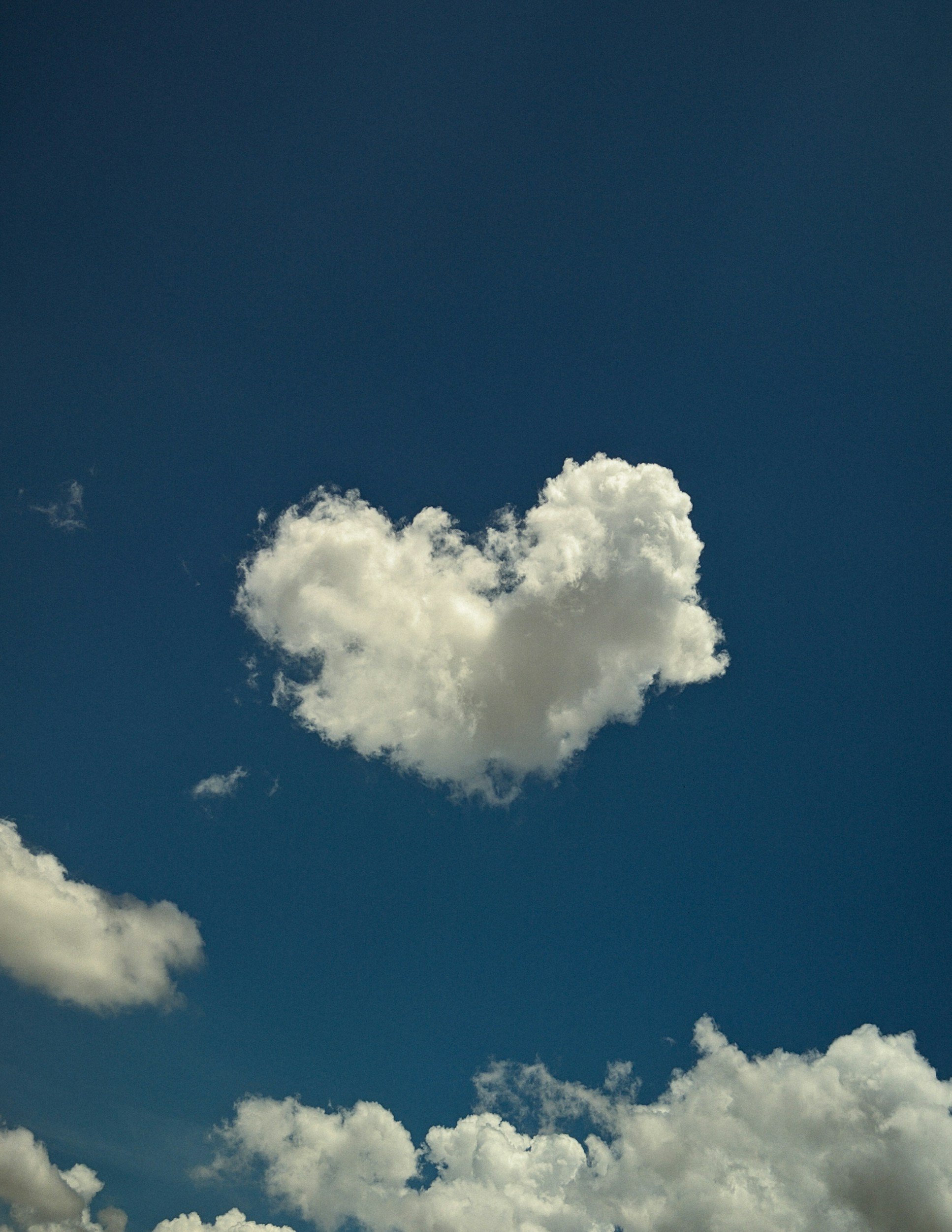 Blue sky with white fluffy clouds scattered across the lower part of the image.