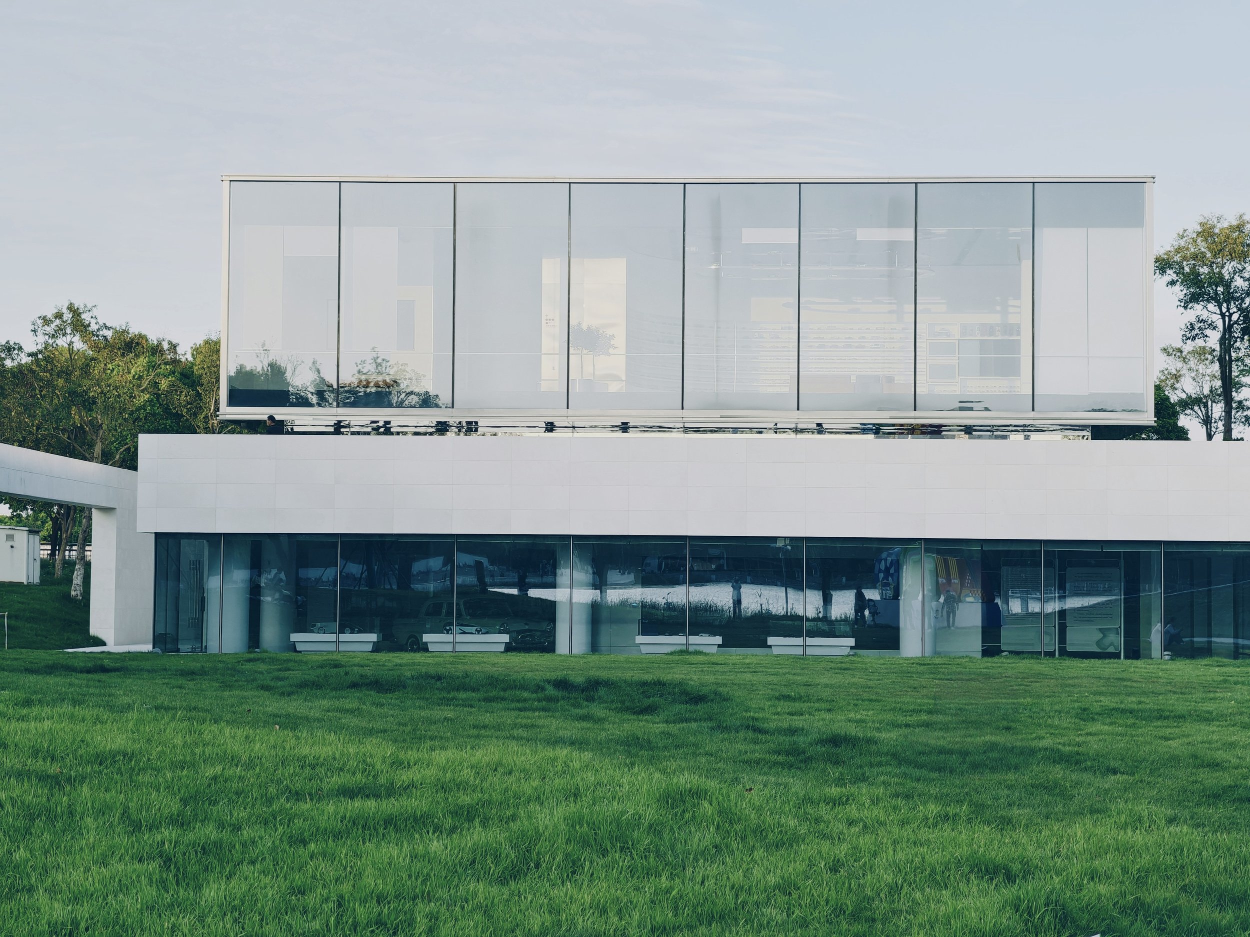 Modern building with reflective glass windows and lawn beside text about commercial property stewardship for HOAs, boards, and congregations in South Metro Atlanta.