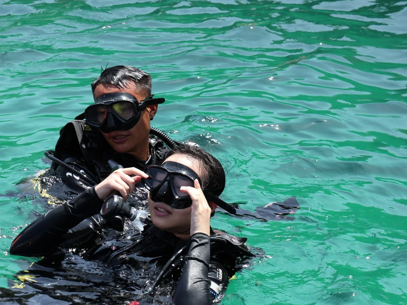 GoBuddy instructor supporting a diver at the surface in Phuket