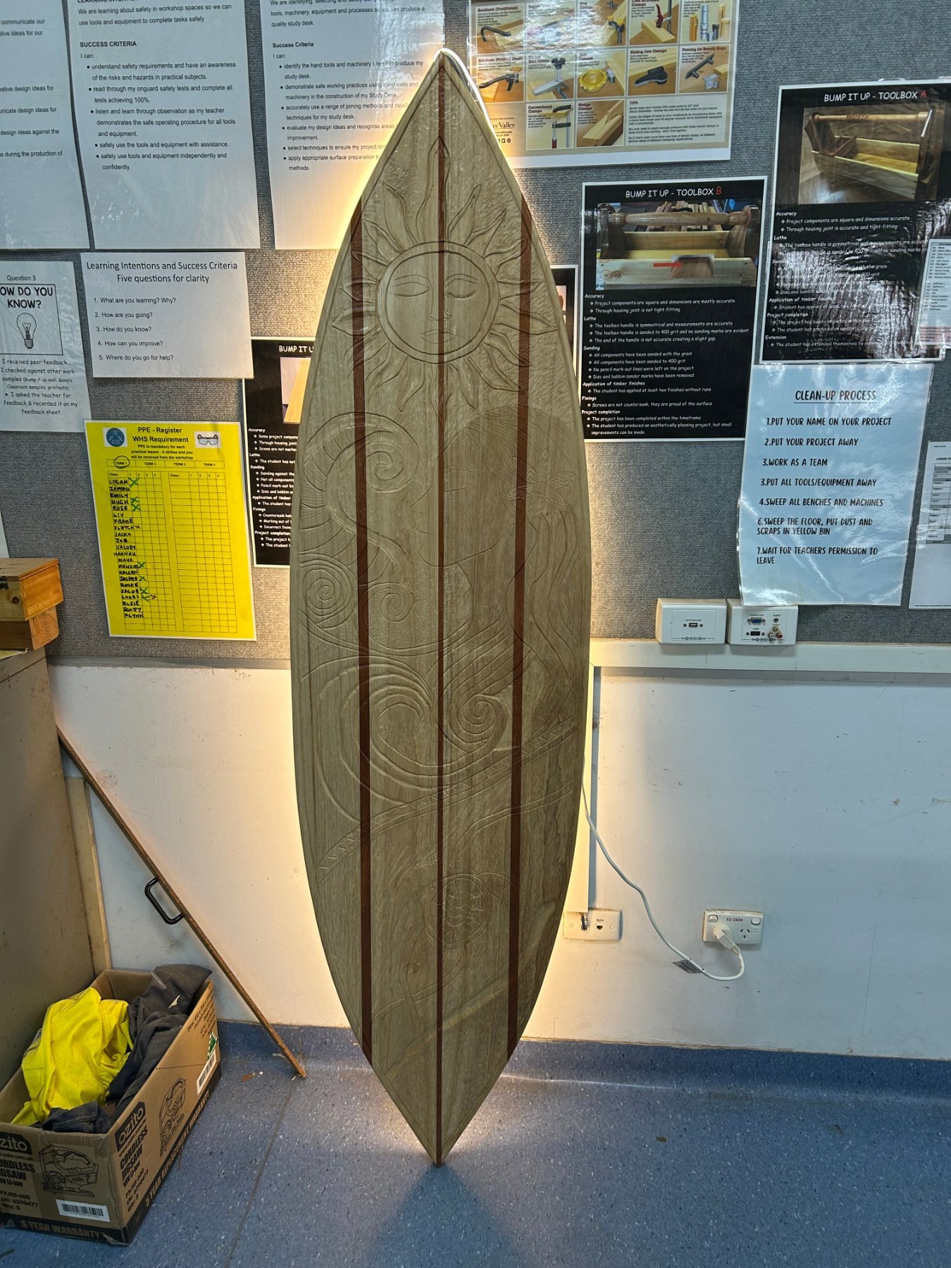 Carved Paulownia surfboard with inlaid timber stripes, built by Alanah for her Year 12 Major Work