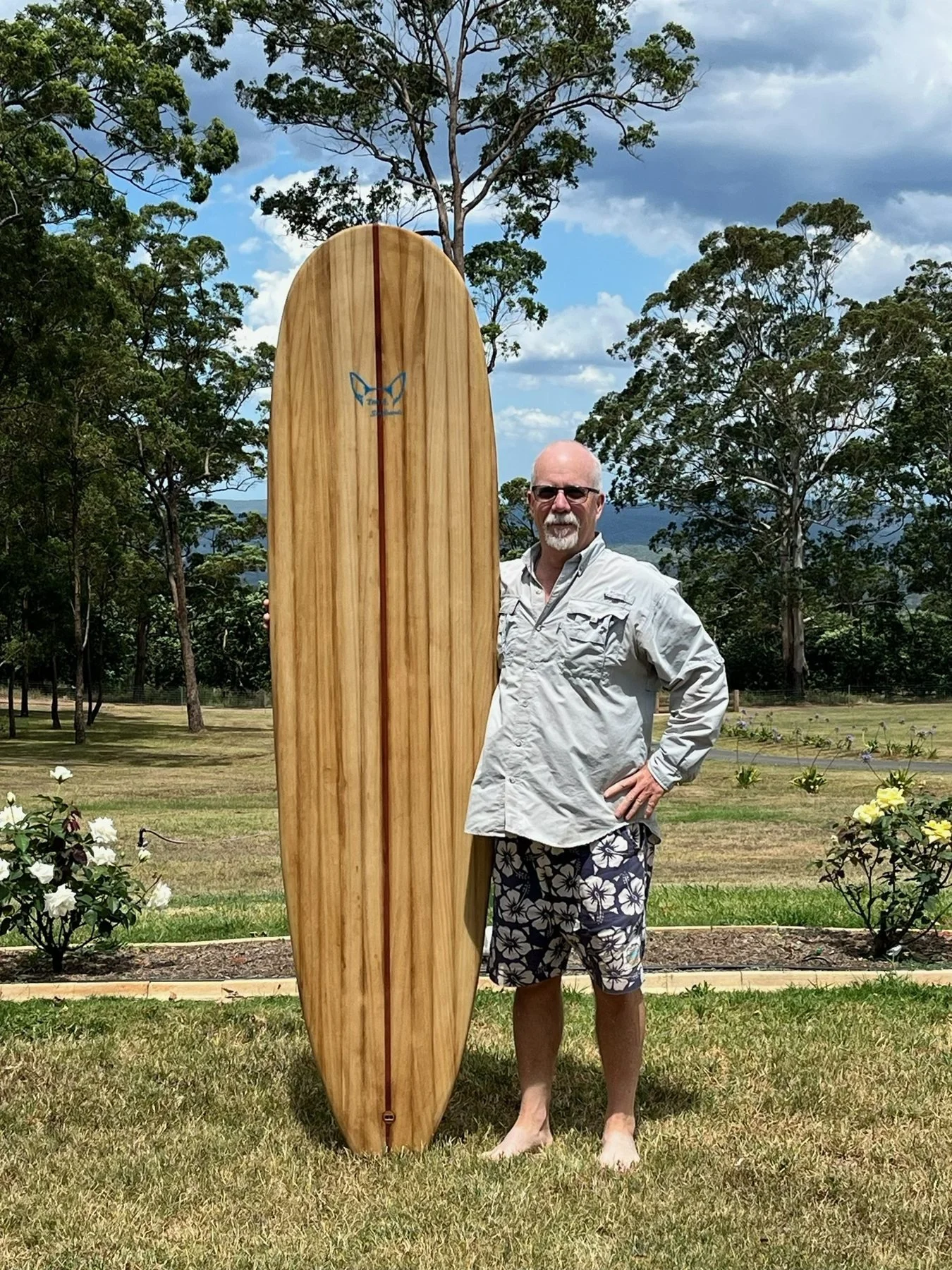 Tom with his finished chambered Paulownia wooden surfboard in Queensland