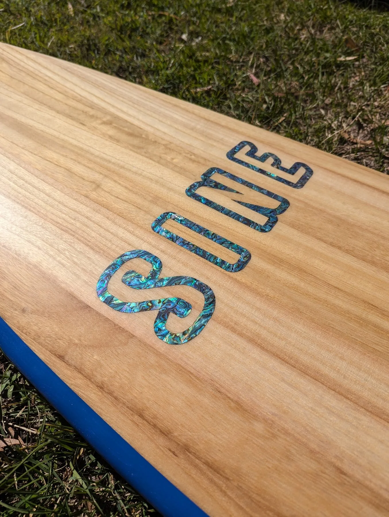 Paulownia surfboard with an inlaid logo