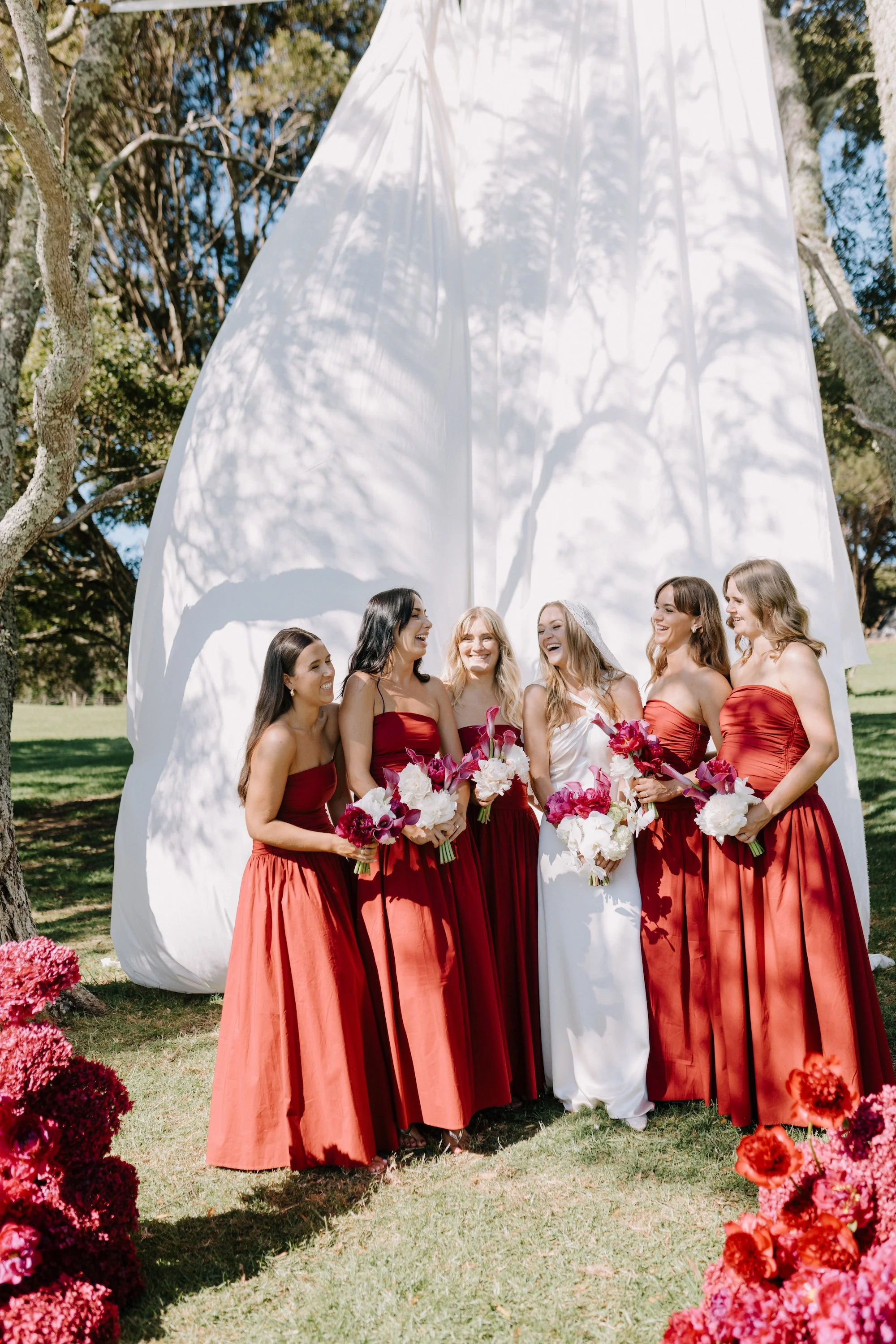 Red bridesmaids dresses with burgundy calla lily bouquets
