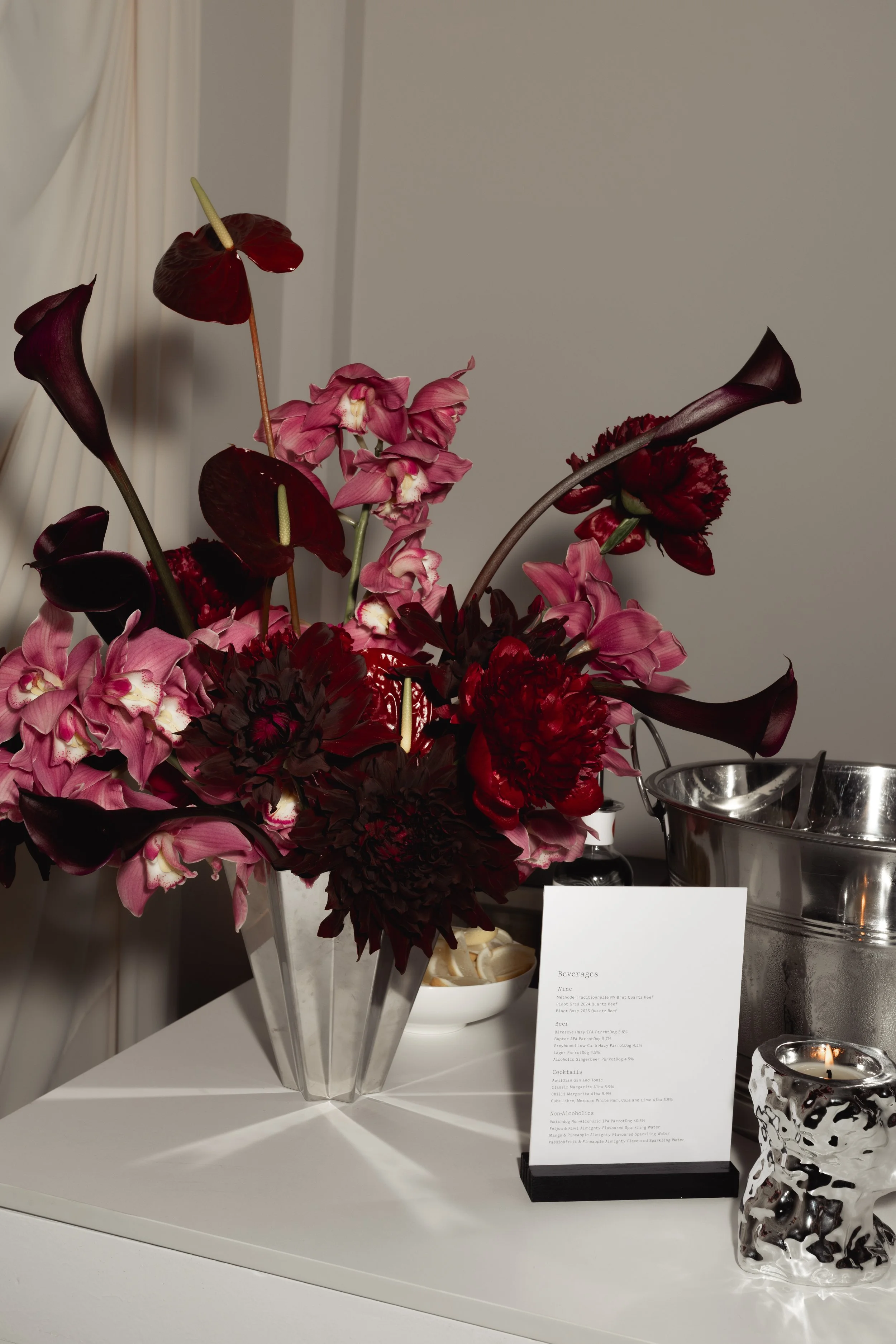 Vase arrangement in deep burgundy and pink tones