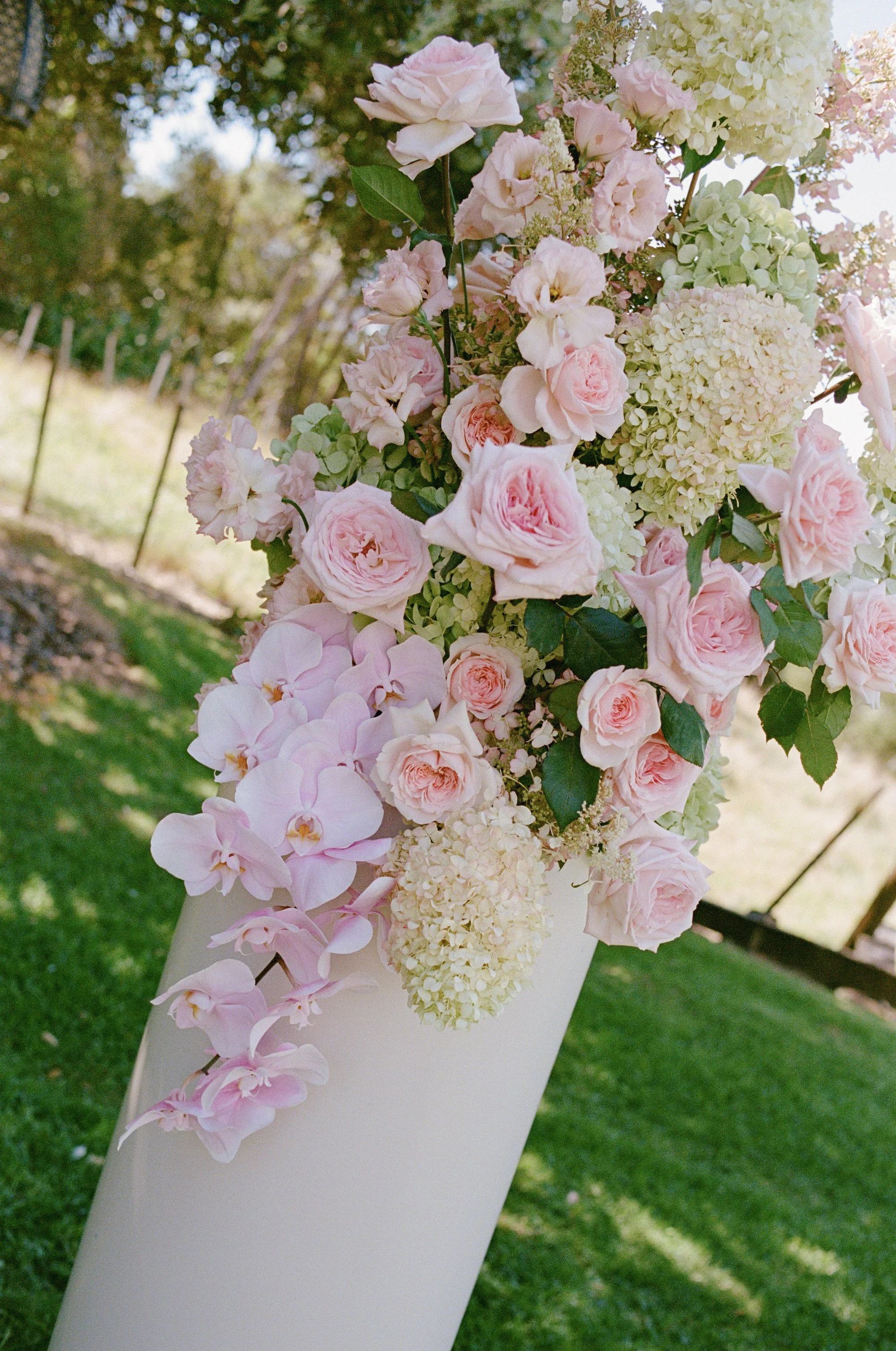 Plinth arrangement in pink and green tones